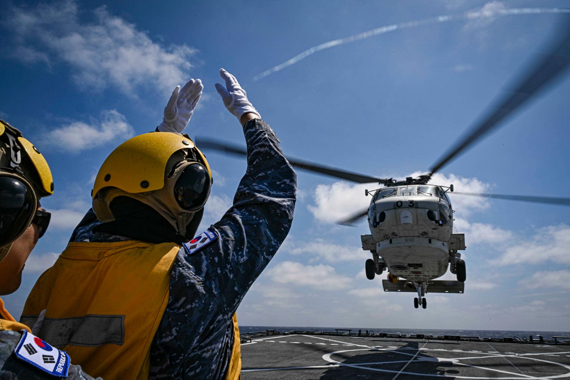 Japan Maritime Self-Defense Force helicopter lands on South Korean Navy amphibious ship during SAREX drill southeast of Jeju Island June 2026