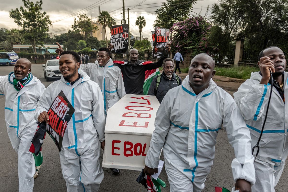 Activists carry a mock coffin during a protest against the US-built Ebola quarantine centre in Kenya