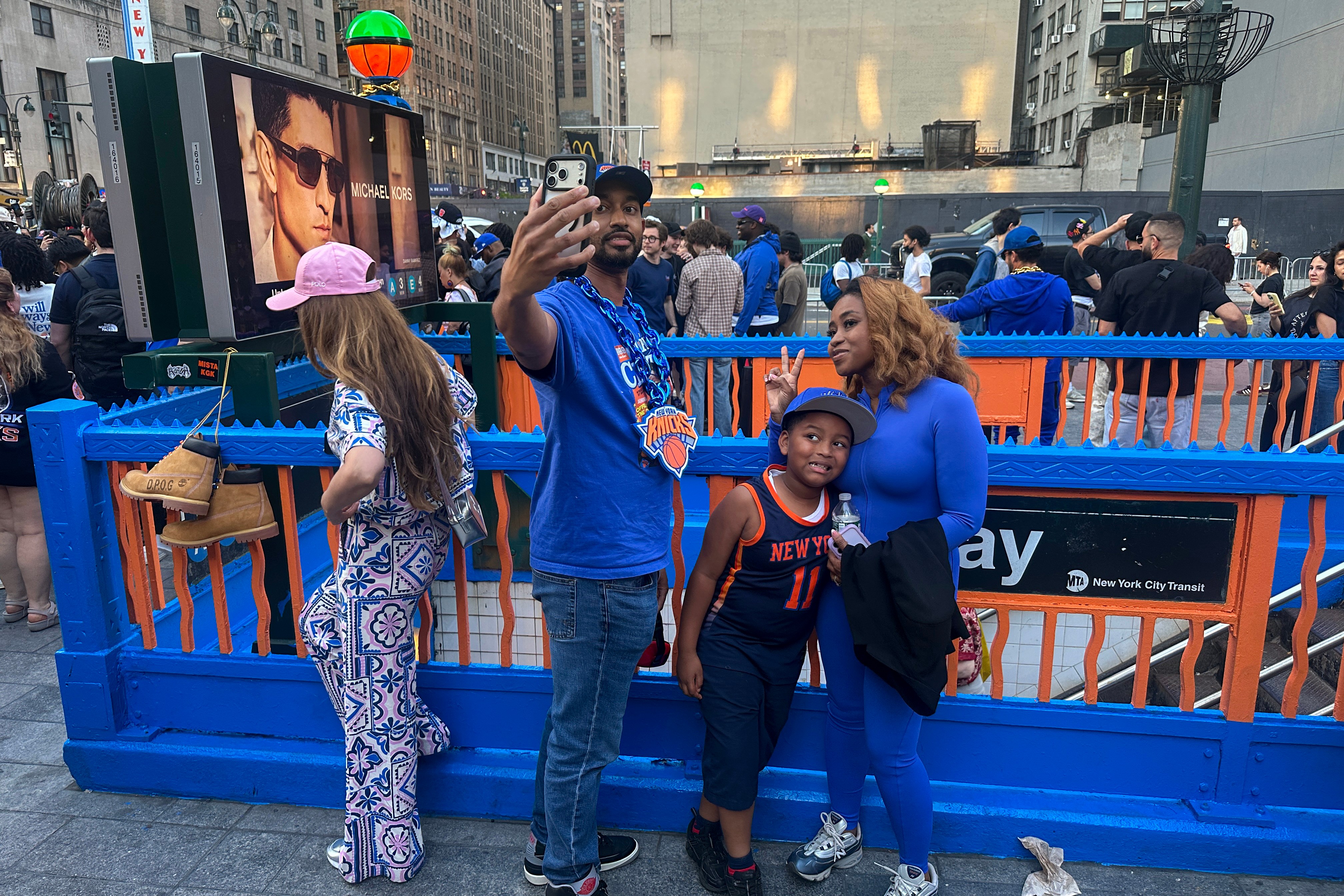 Knicks fans celebrate at a decorated New York City subway entrance during the 2026 NBA Finals
