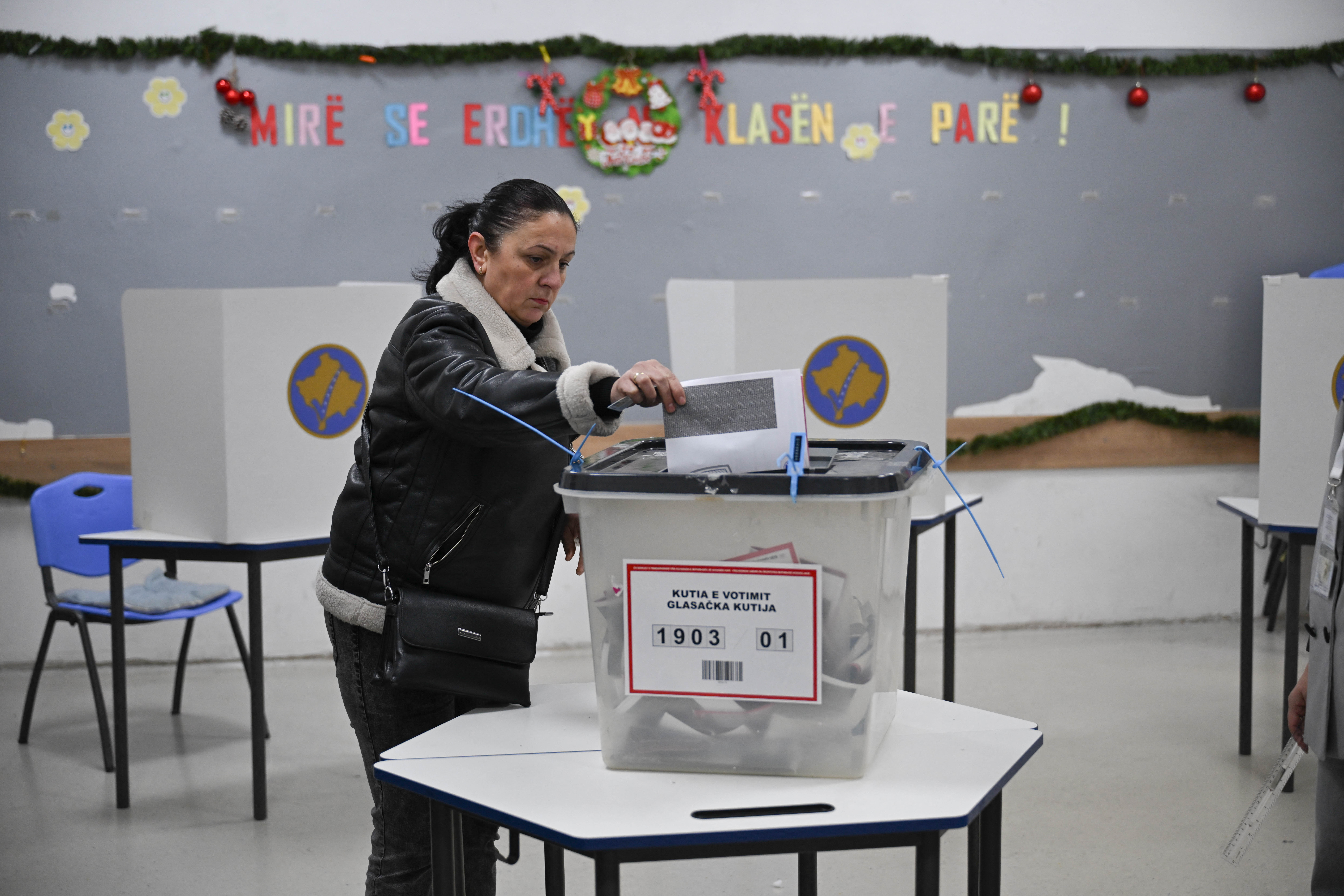 A voter casts a ballot at a polling station in Pristina during Kosovo's snap election