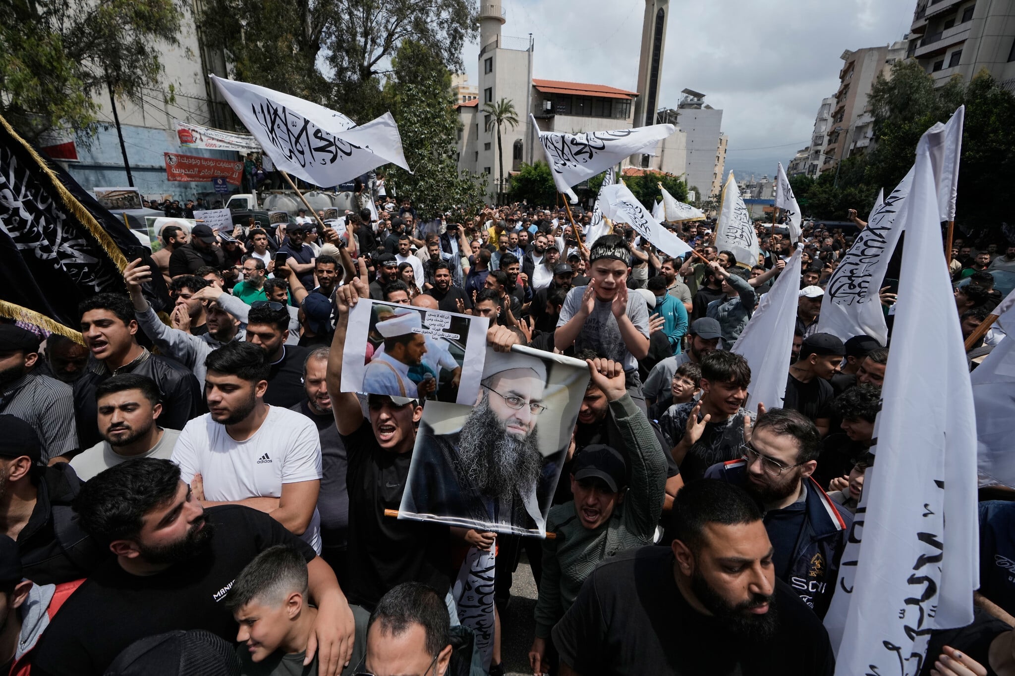 Sunni Muslims hold portrait of imprisoned cleric Ahmad al-Assir during protest against Lebanon amnesty law in Beirut