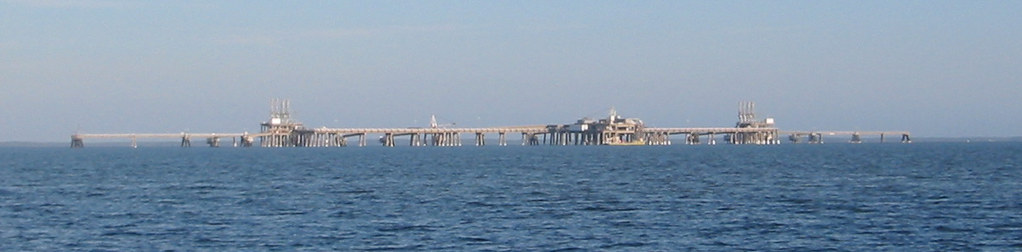 An LNG terminal with storage tanks, illustrating a liquefied natural gas story