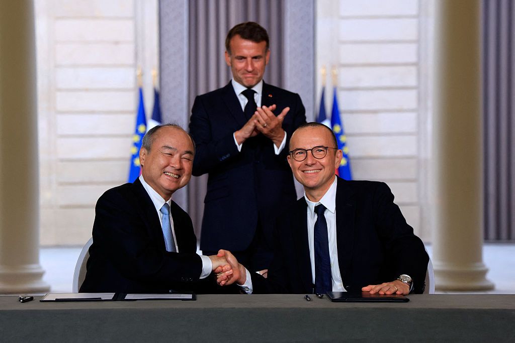Emmanuel Macron watches SoftBank CEO Masayoshi Son and Schneider Electric CEO Olivier Blum sign agreements at the Elysee Palace Paris June 2026