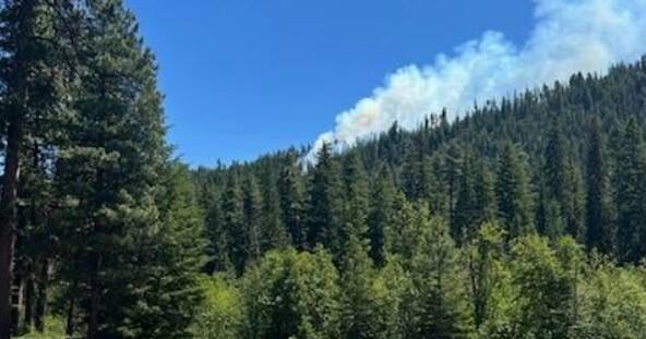 Smoke rises from the crash site of a Marine Corps F/A-18 Hornet near Rimrock Lake in Yakima County Washington