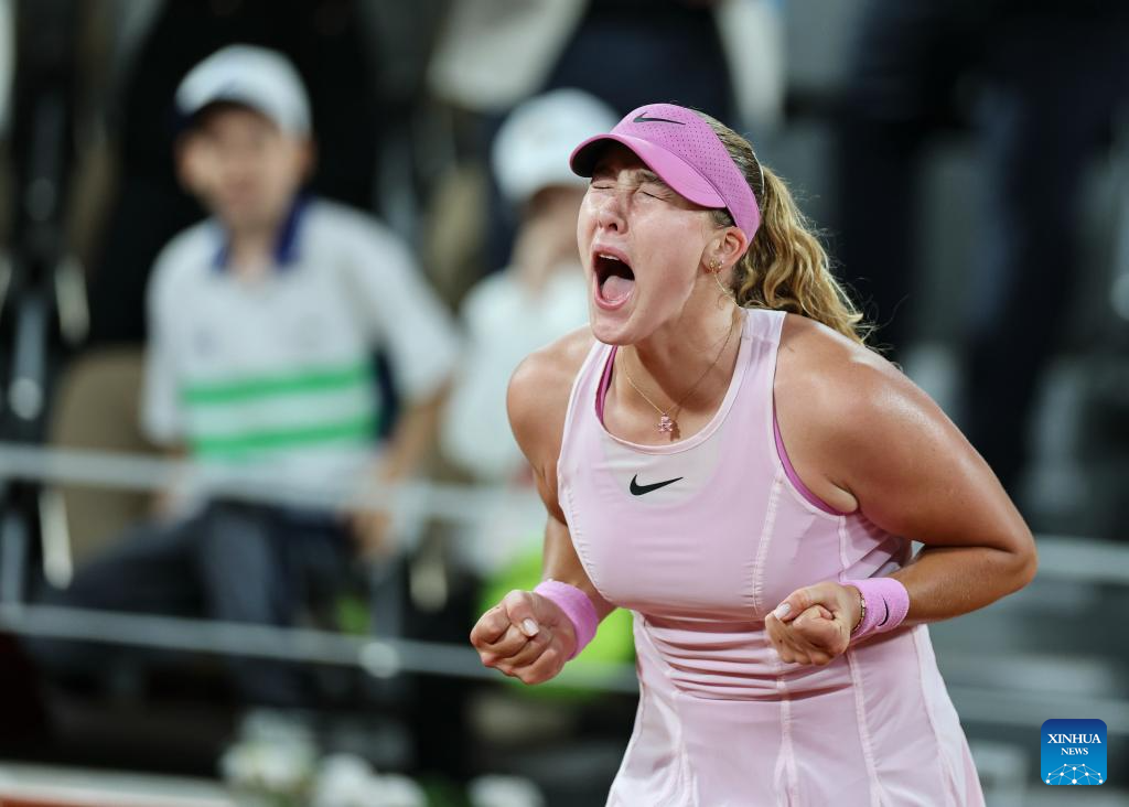 Mirra Andreeva celebrates after defeating Marta Kostyuk to reach the 2026 French Open final at Roland Garros