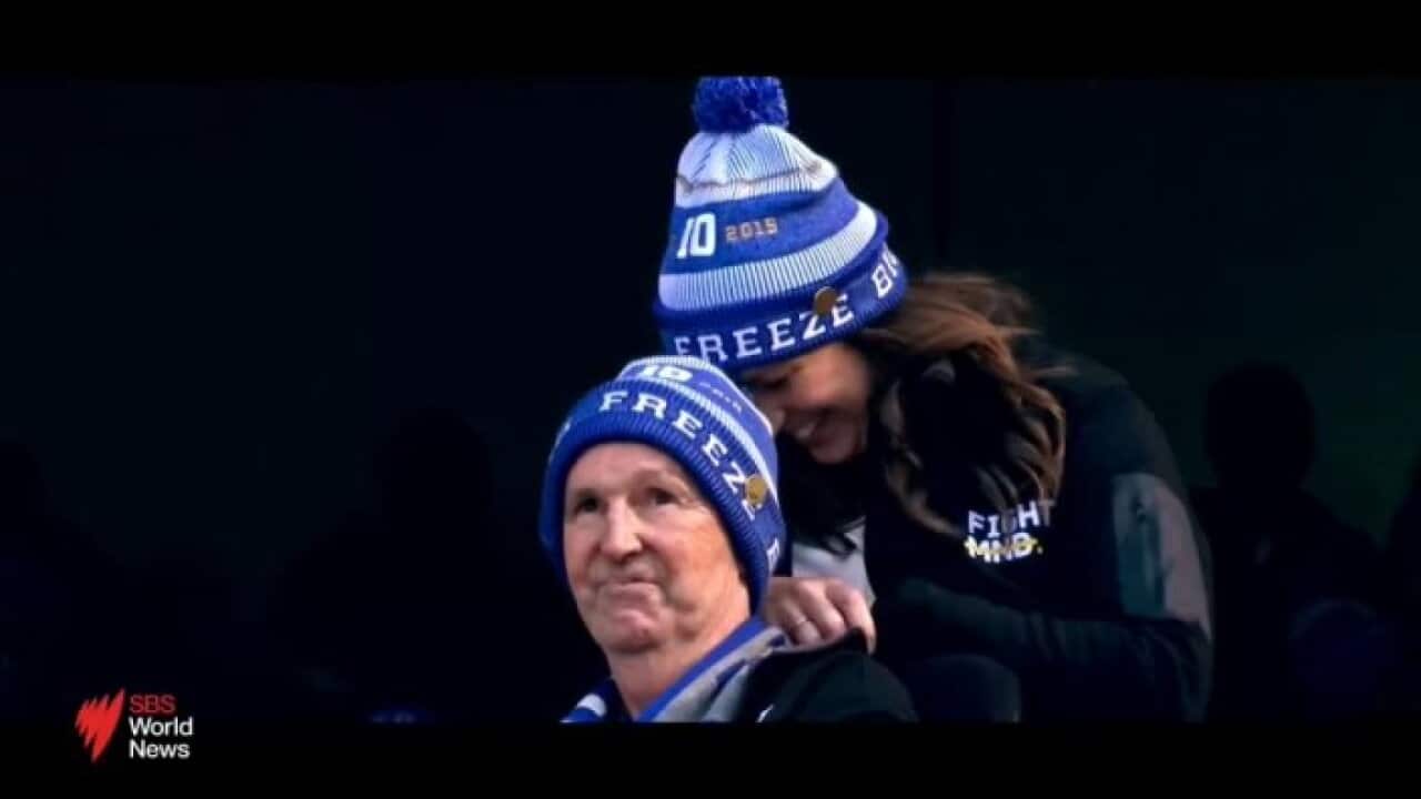 Mourners in blue beanies at Neale Daniher MCG state funeral