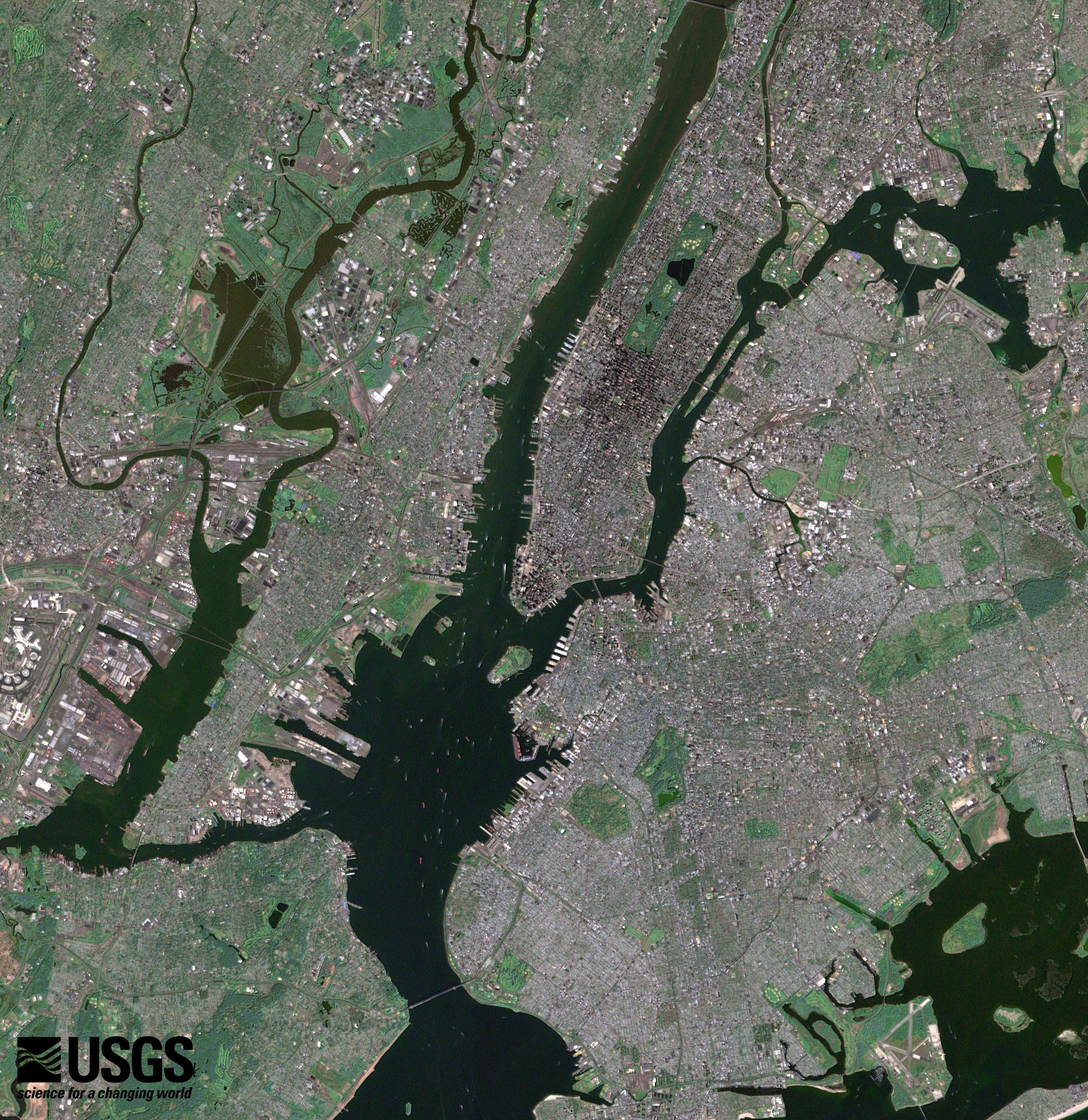 NASA Landsat 7 ETM+ satellite image of New York City showing southern Manhattan with the Financial District at the southern tip the Hudson River the East River Ellis Island Brooklyn Queens and the bridges connecting the boroughs