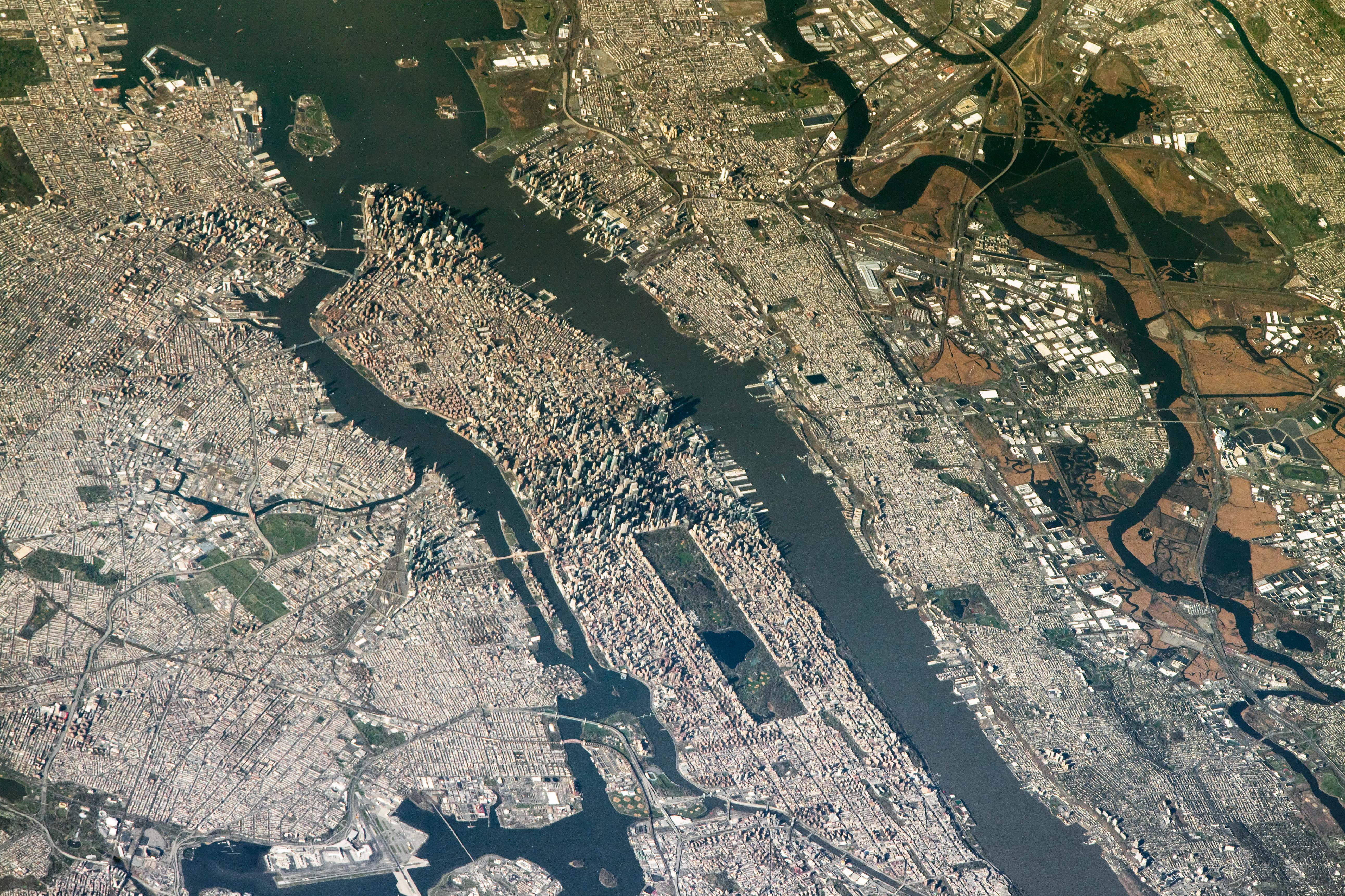 NASA astronaut photograph from the International Space Station of New York City and New Jersey from an oblique angle showing Manhattan the Hudson River New Jersey and the East Rutherford MetLife Stadium area