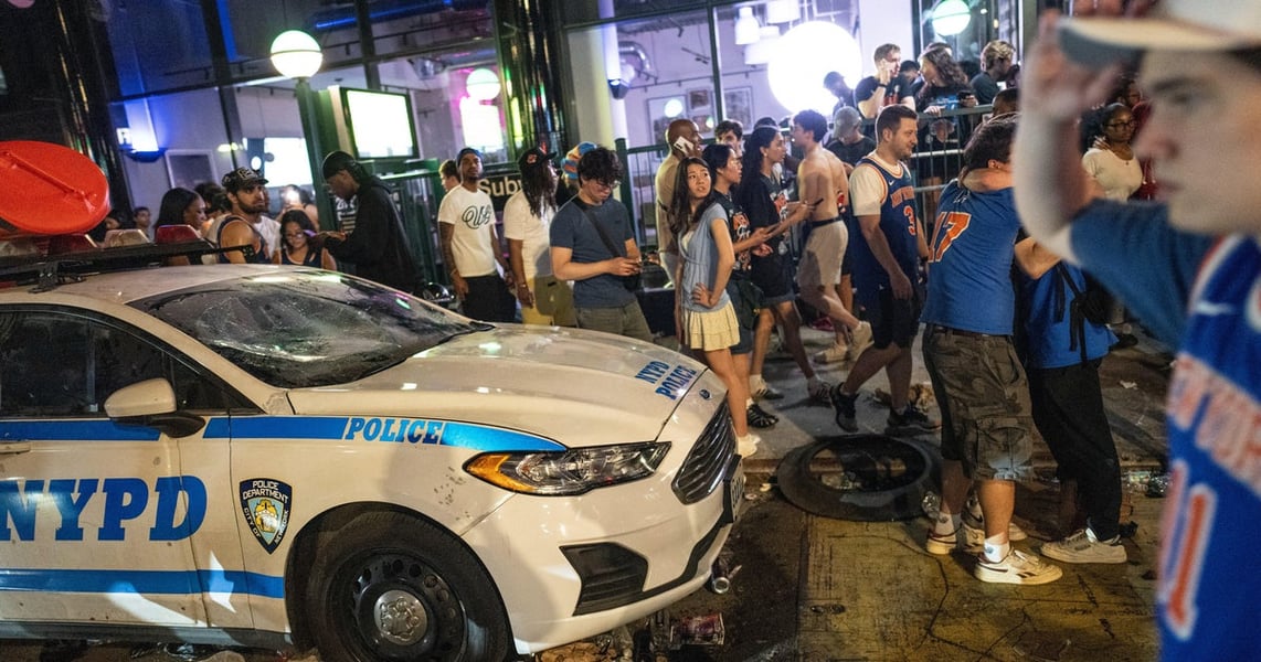 NYPD officers in riot gear amid Knicks championship celebration violence in Times Square New York 2026