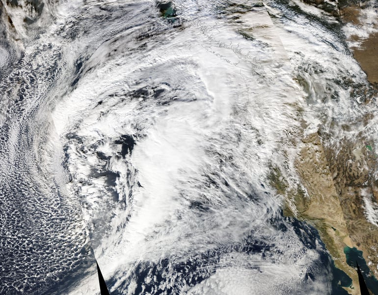 NASA MODIS satellite view of severe storm systems over the Pacific Ocean approaching the West Coast of the United States