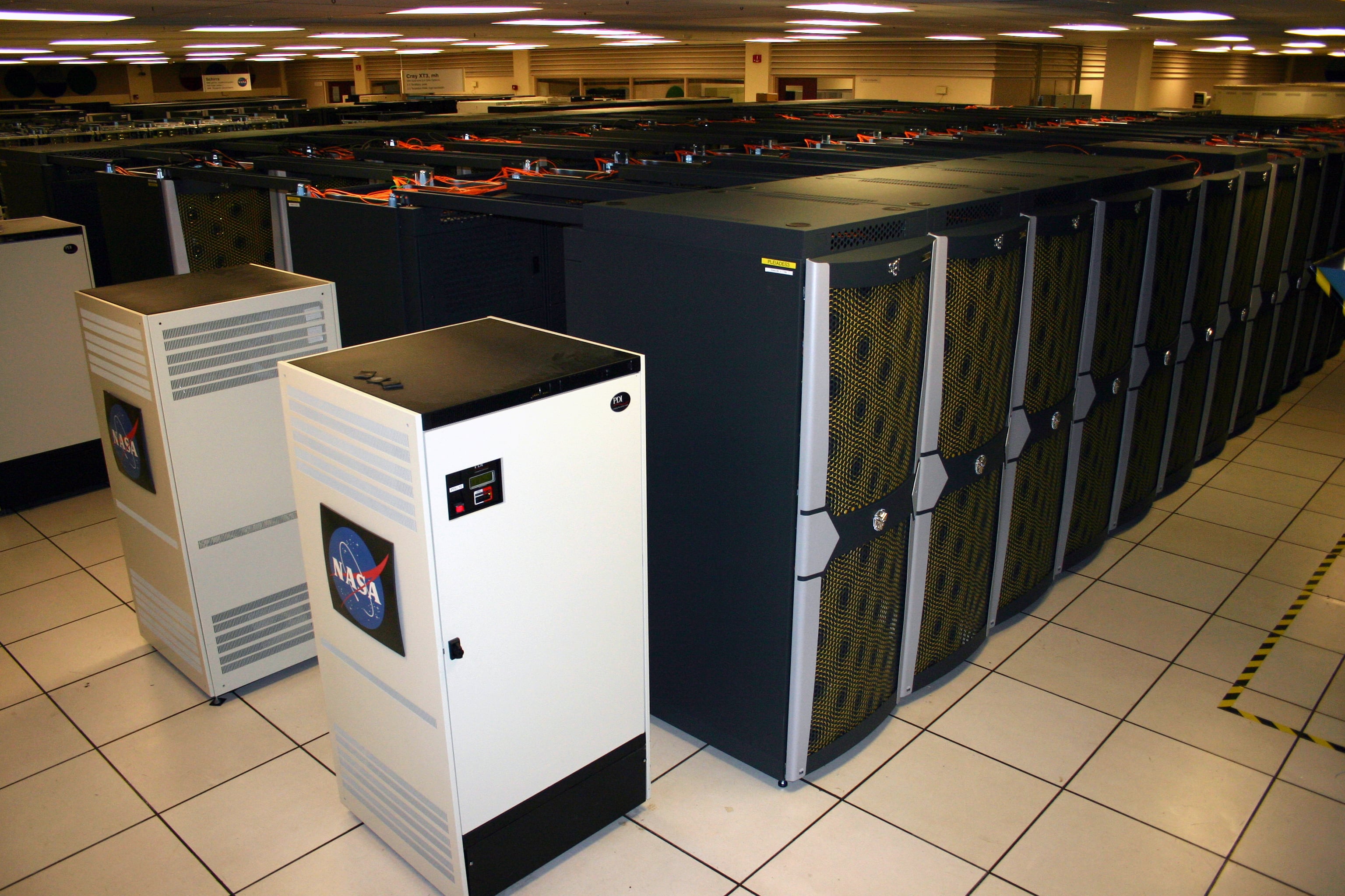 Rows of supercomputer server racks at NASA's Ames Research Center, representing modern high-performance computing infrastructure