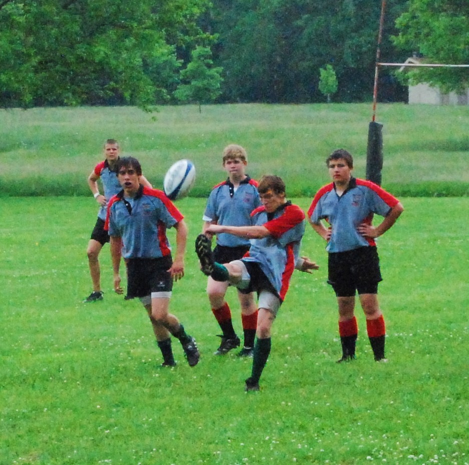 A rugby union ball being kicked on a field, illustrating a rugby story