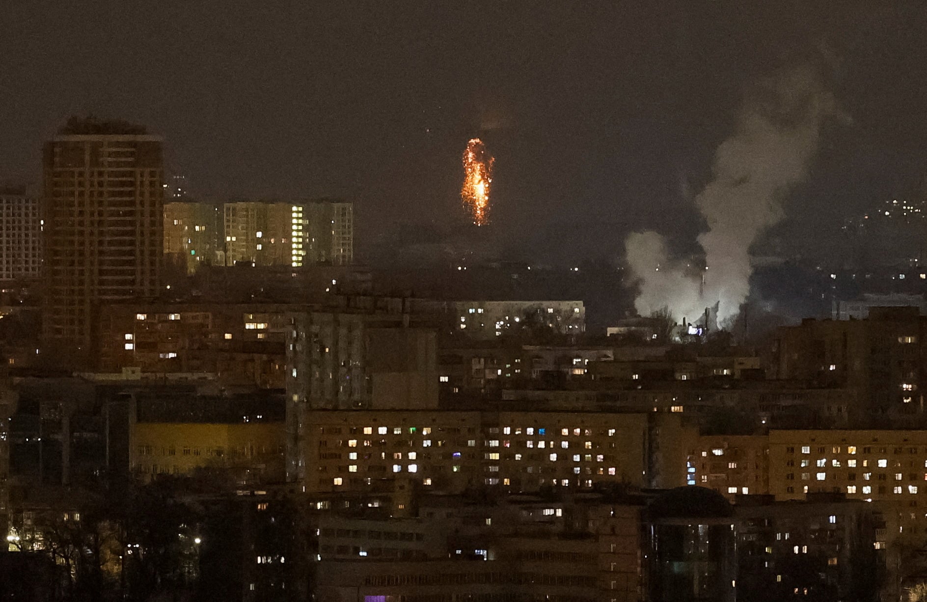 A Ukrainian drone explodes in the night sky over Kyiv during a Russian drone strike