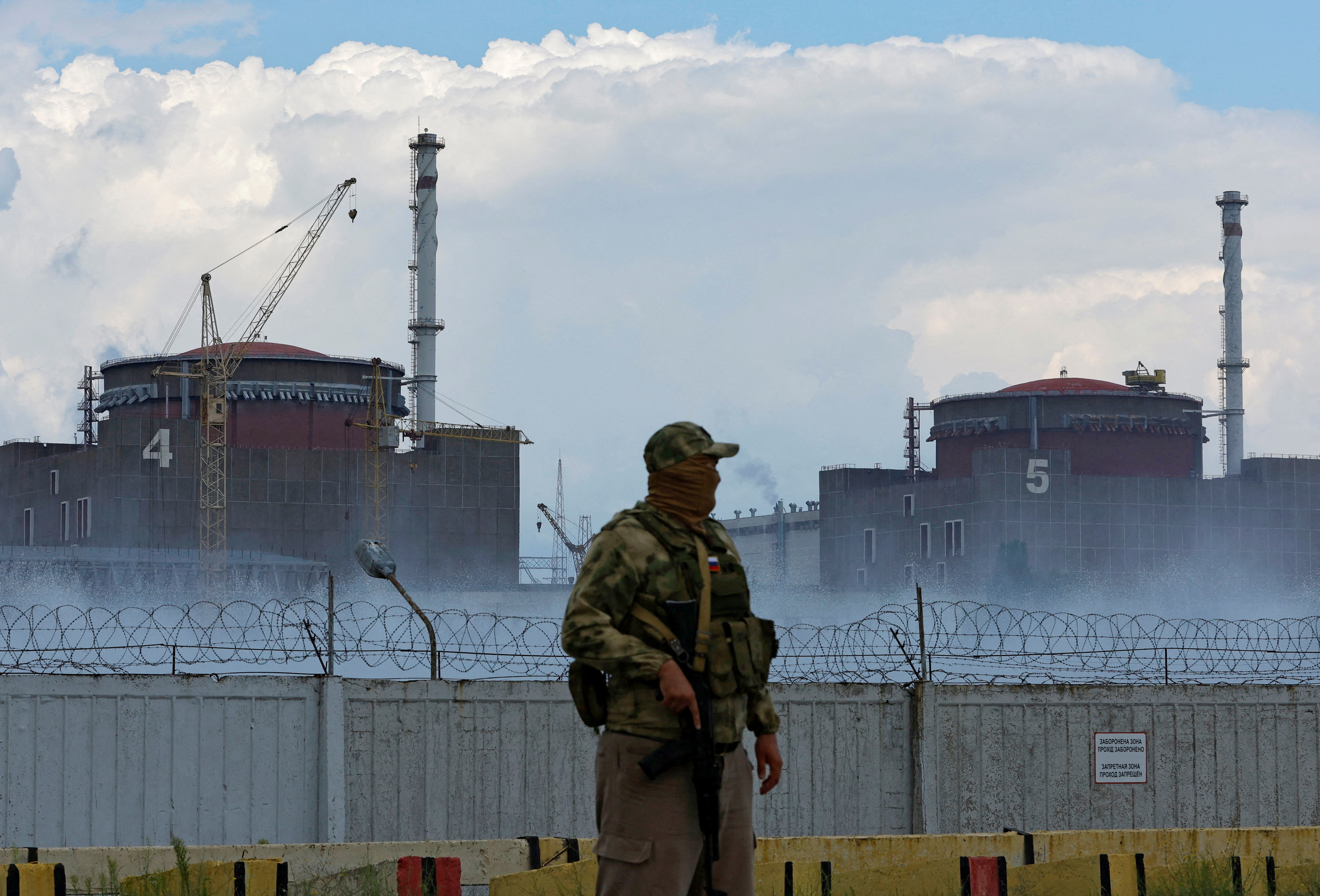 Russian serviceman stands guard near Zaporizhzhia nuclear power plant in Ukraine