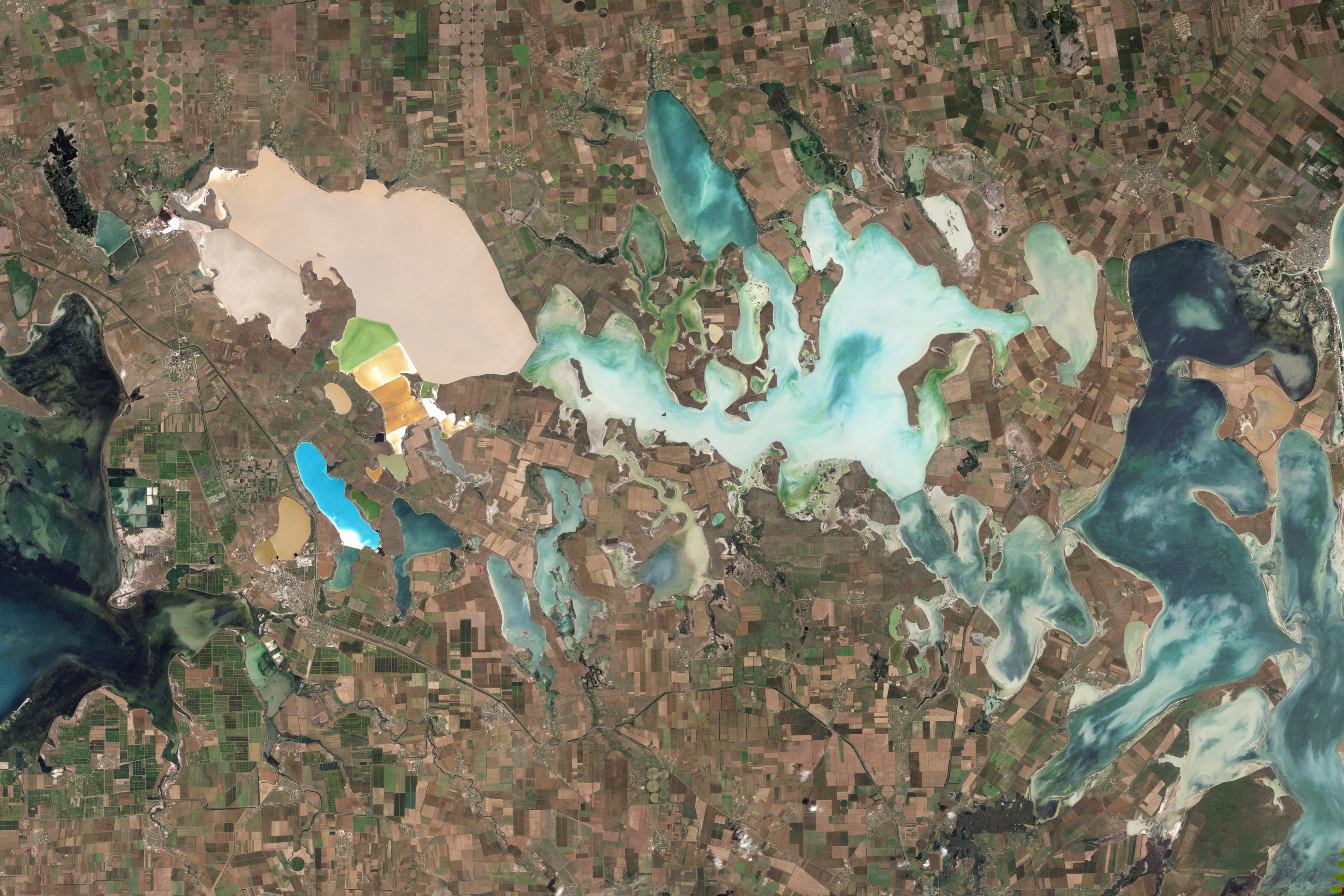 NASA Landsat 5 Thematic Mapper natural-color satellite image of the Sivash salt lagoons between the Black Sea and the Sea of Azov showing the narrow Perekop Isthmus that connects Crimea to mainland Ukraine and the Armiansk bridge corridor