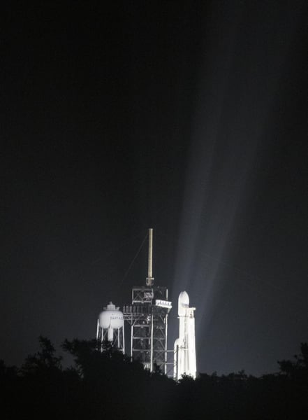 A SpaceX Falcon Heavy rocket lifts off at night from Kennedy Space Center