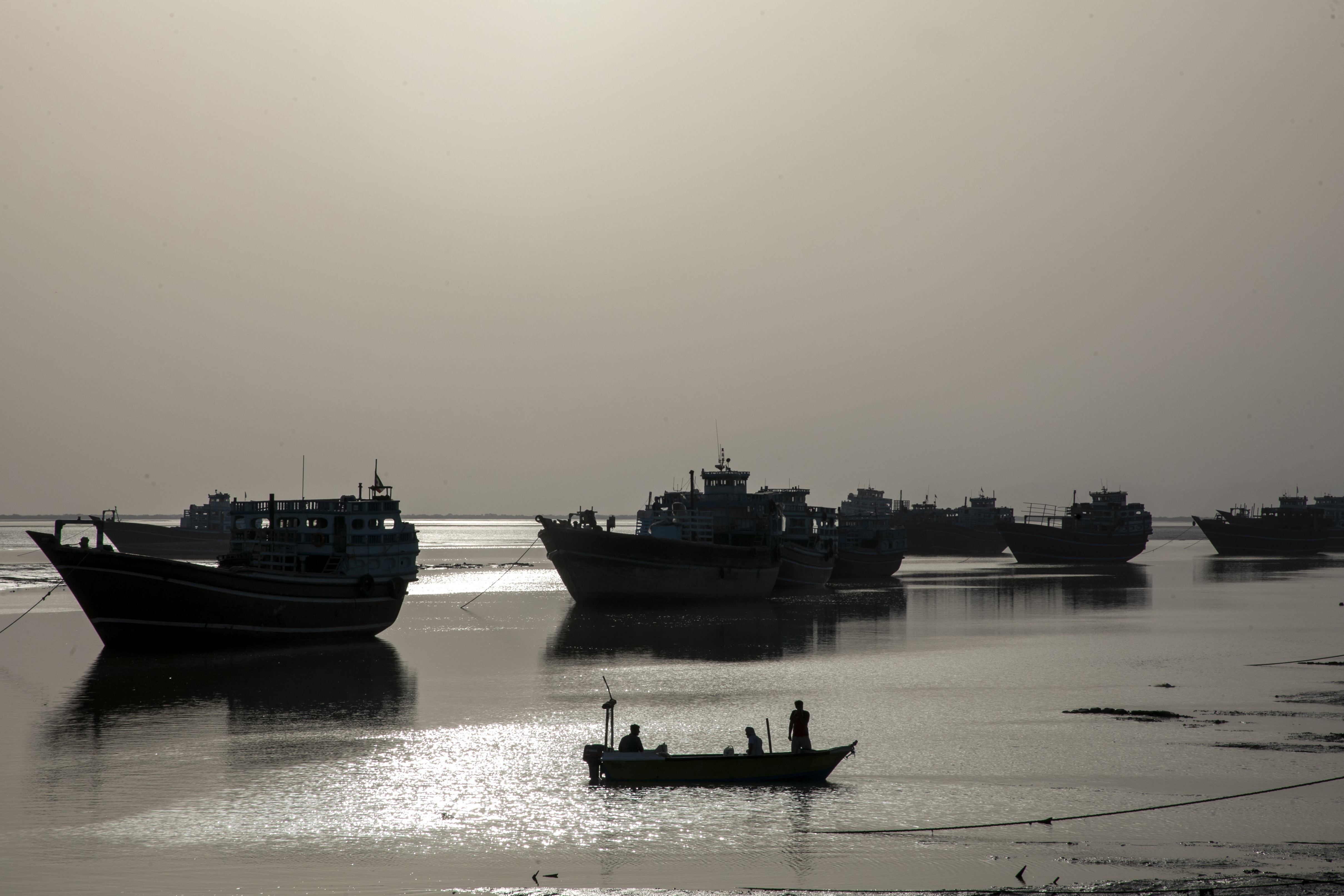 Fishing boats along the Strait of Hormuz, where US strikes on Iranian ports triggered Iran's retaliation against Bahrain and Kuwait