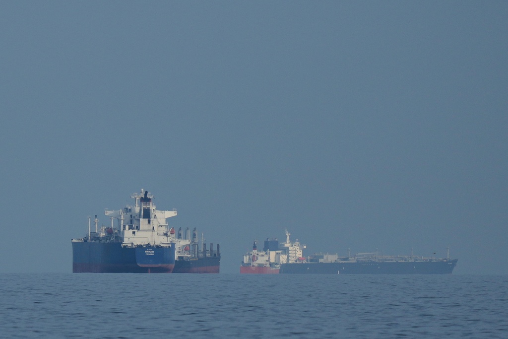 Oil tankers and cargo ships anchored in the Strait of Hormuz near Khor Fakkan, United Arab Emirates
