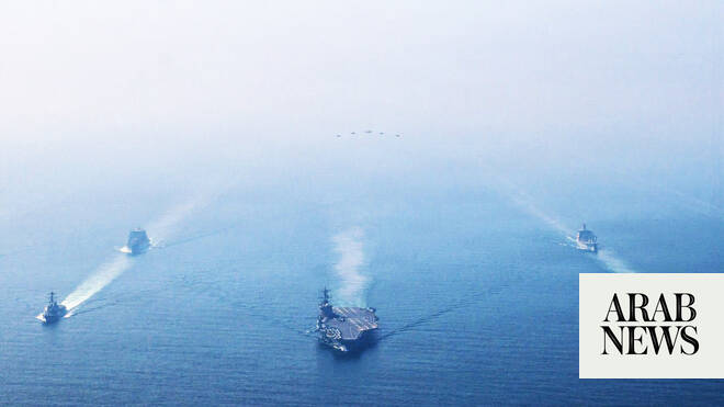 Commercial vessels navigating the Strait of Hormuz off Oman coast during US naval blockade of Iranian ports