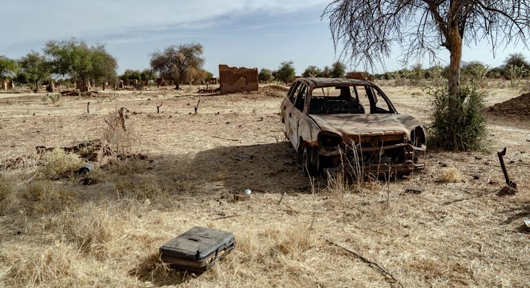 Burnt shell of a car and destroyed mud-brick homes in abandoned village in North Darfur Sudan