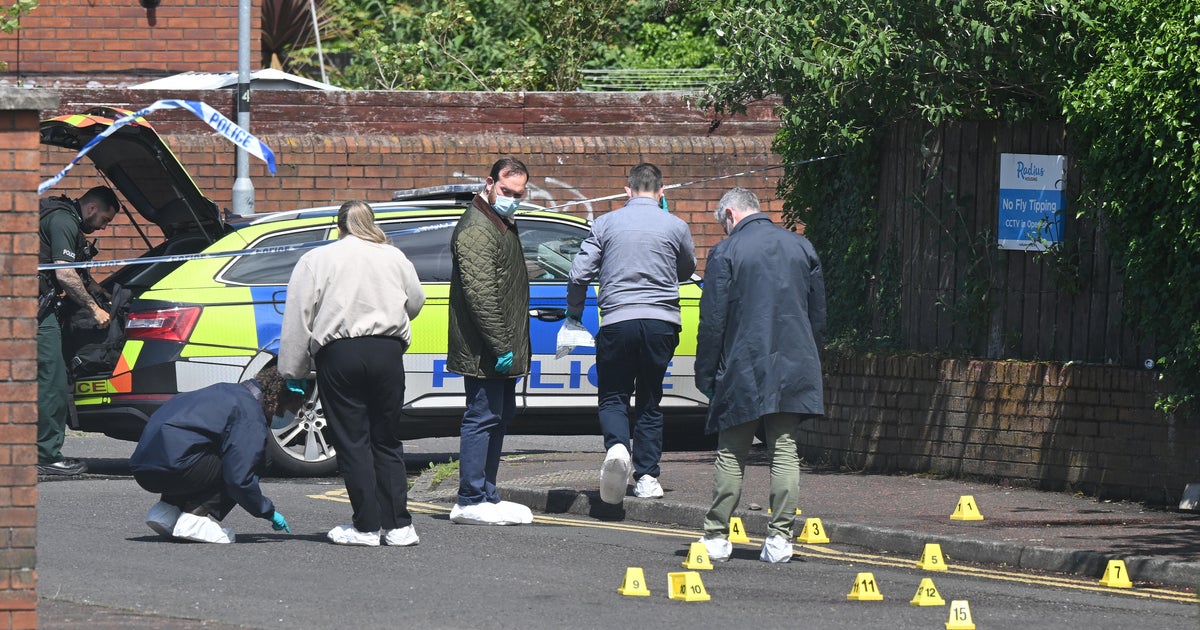 PSNI forensic officers investigate the scene of the stabbing attack on Kinnaird Avenue in north Belfast, Northern Ireland