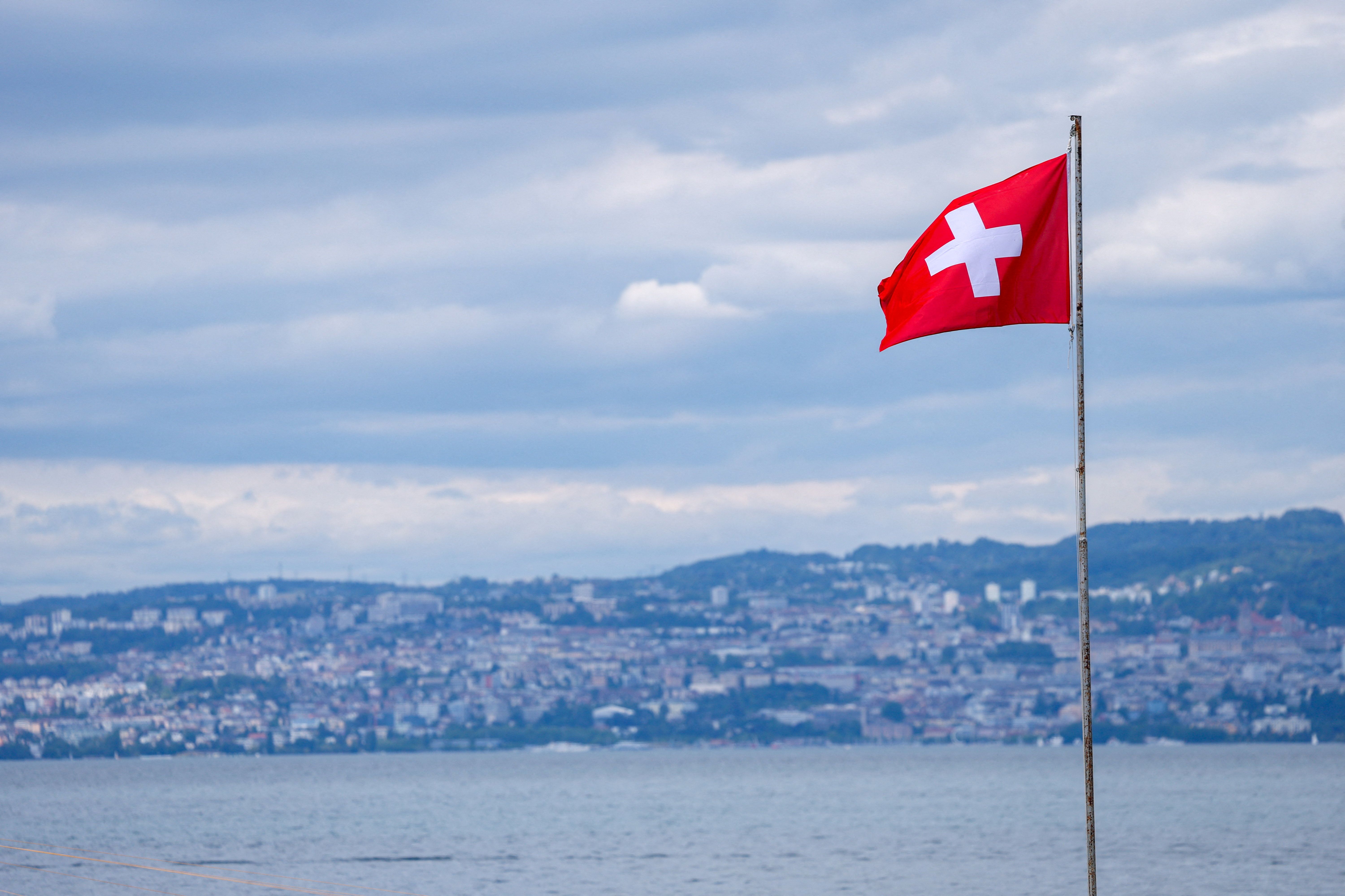 A Swiss flag flies in front of the city of Lausanne ahead of the population cap referendum