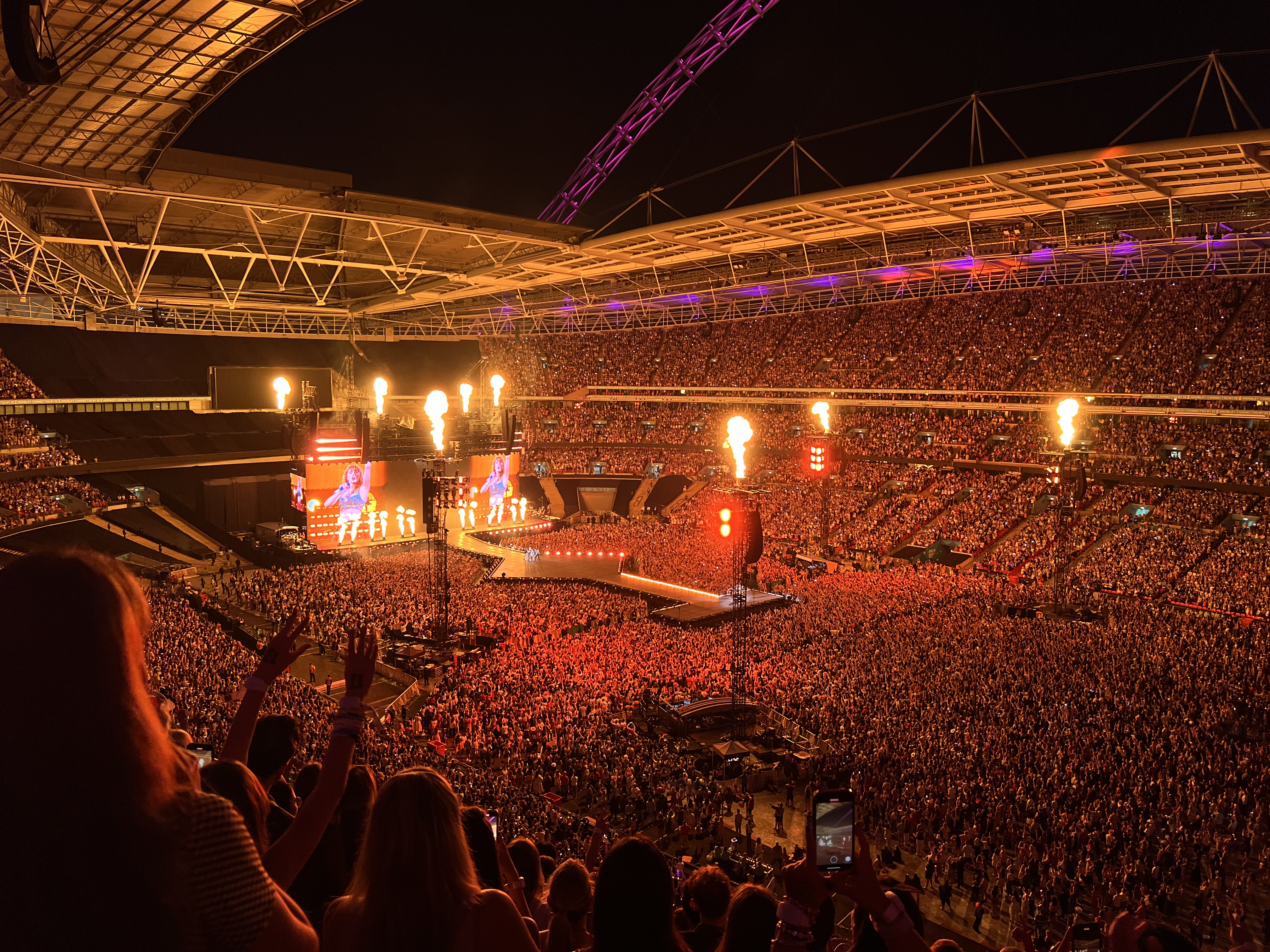 Taylor Swift performing on the Eras Tour in London in August 2024, before her quiet country return