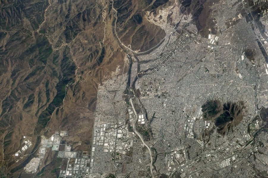 NASA ISS astronaut photograph of Tijuana and the Mexico-US border, showing the urban catchment whose wastewater enters the Tijuana River