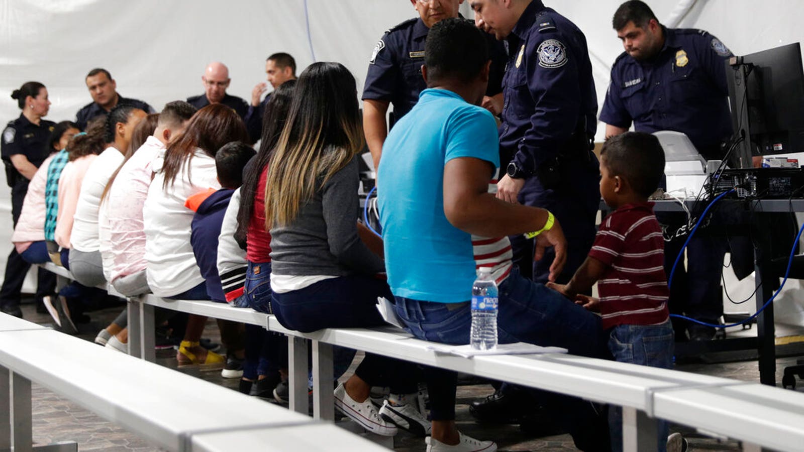 Migrants going through an asylum processing area