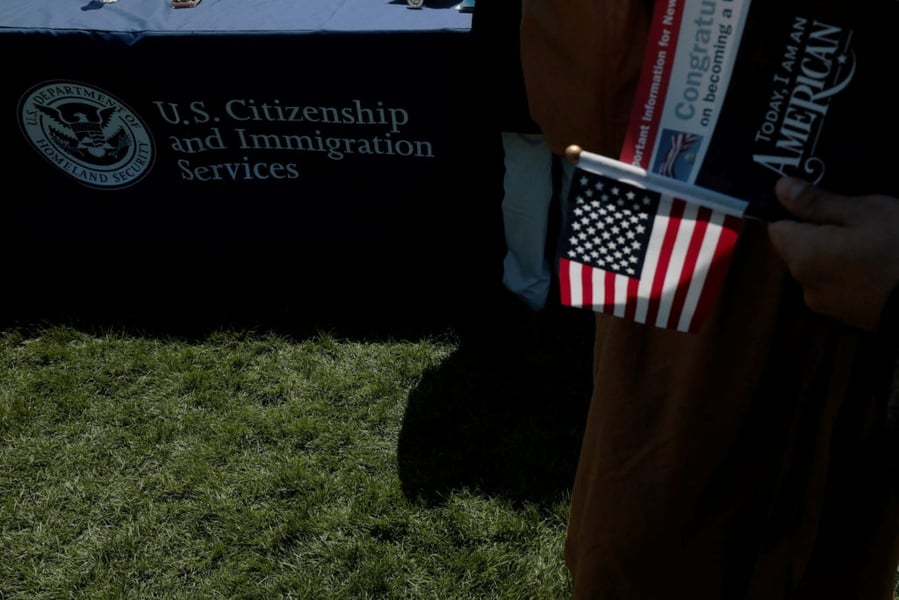 Immigrants at a USCIS naturalization ceremony as Trump administration restricts asylum access