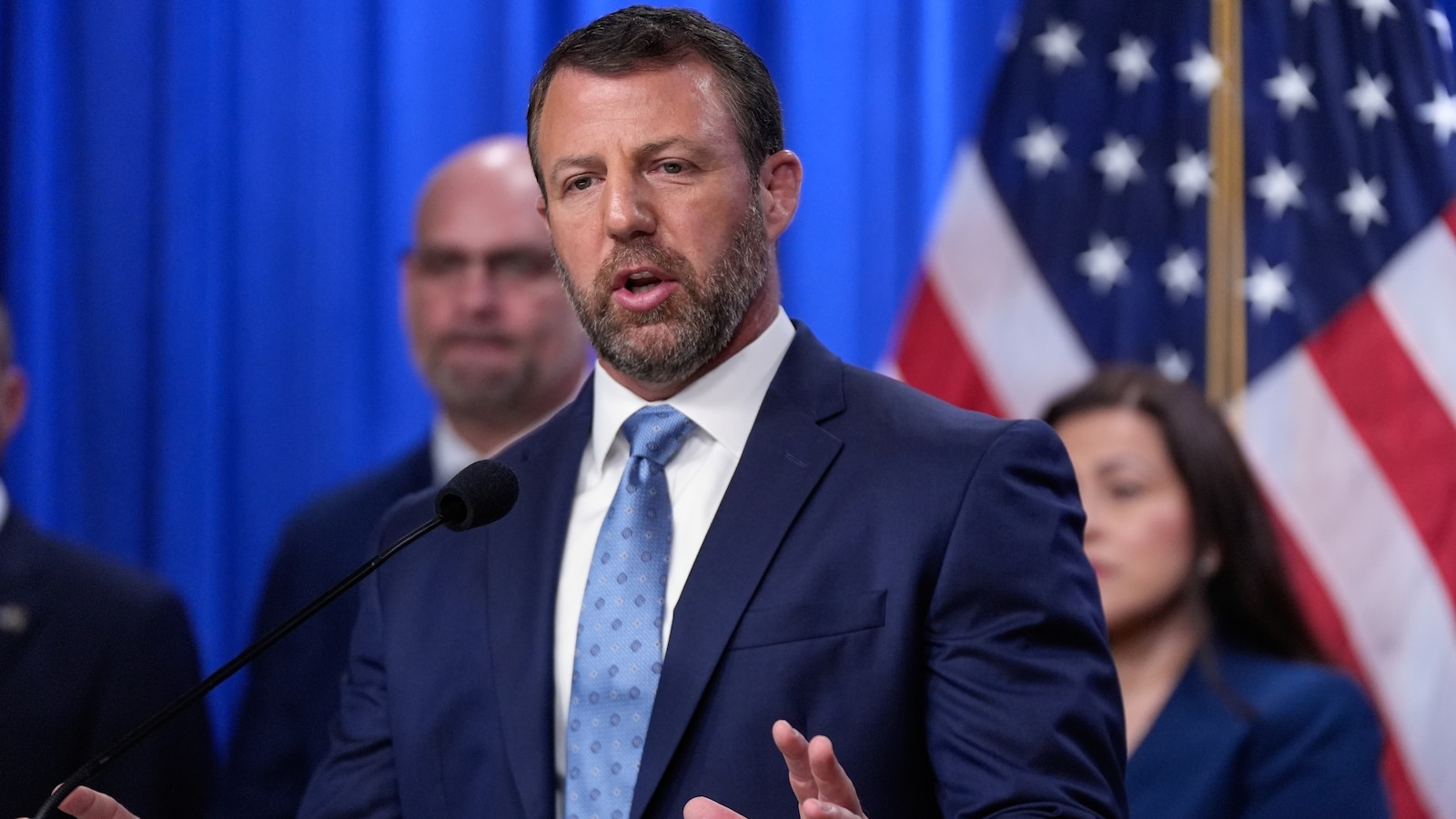 A Homeland Security official speaks at a Justice Department news conference on migrant children