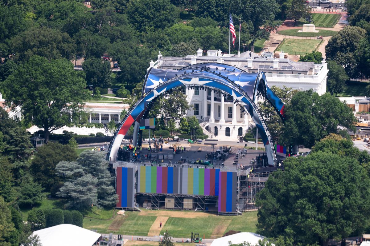 Workers construct an octagon-shaped UFC cage on the South Lawn of the White House