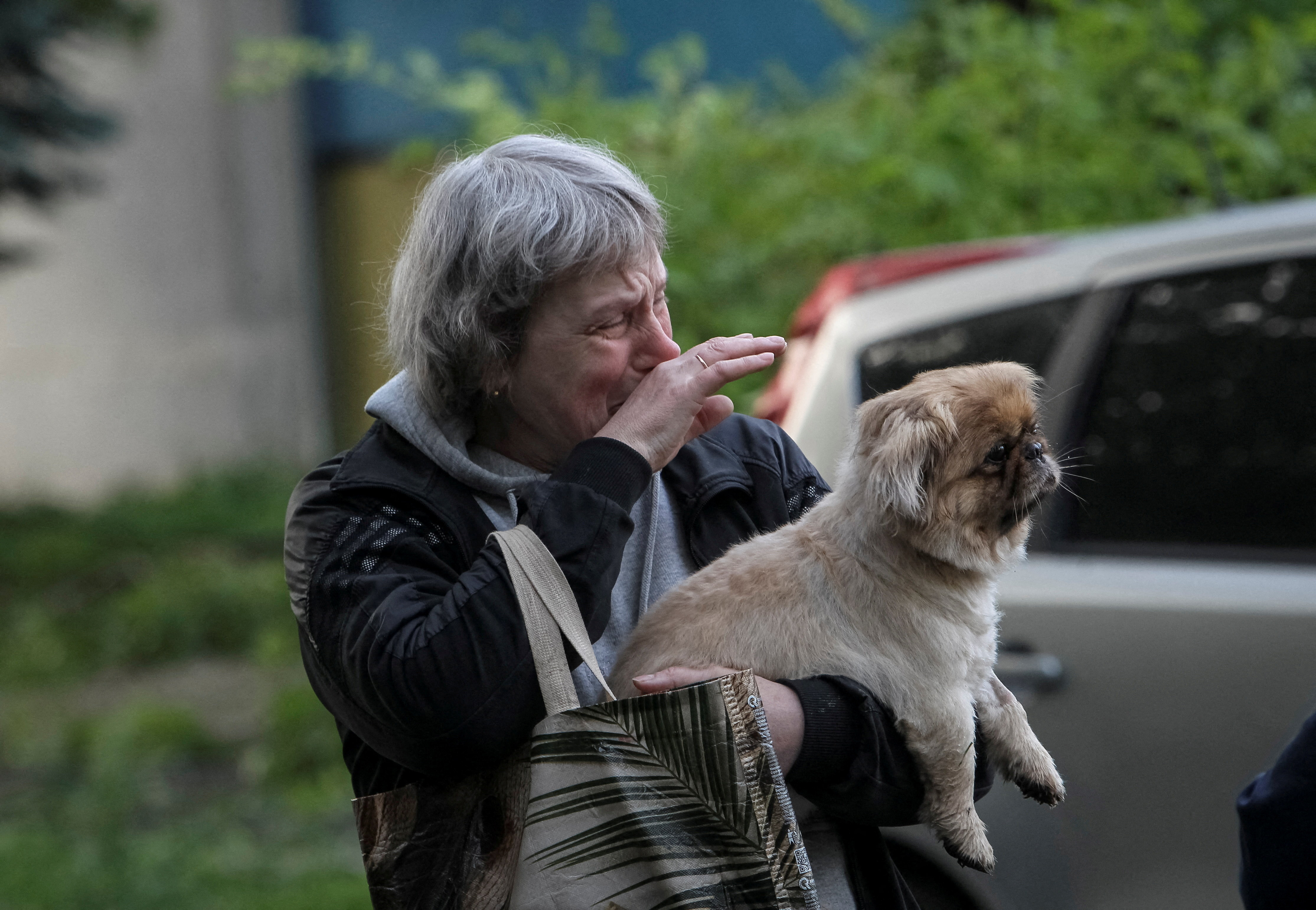 A woman stands amid rubble at an apartment building damaged by a Russian missile attack in Dnipro, Ukraine, May 18, 2026