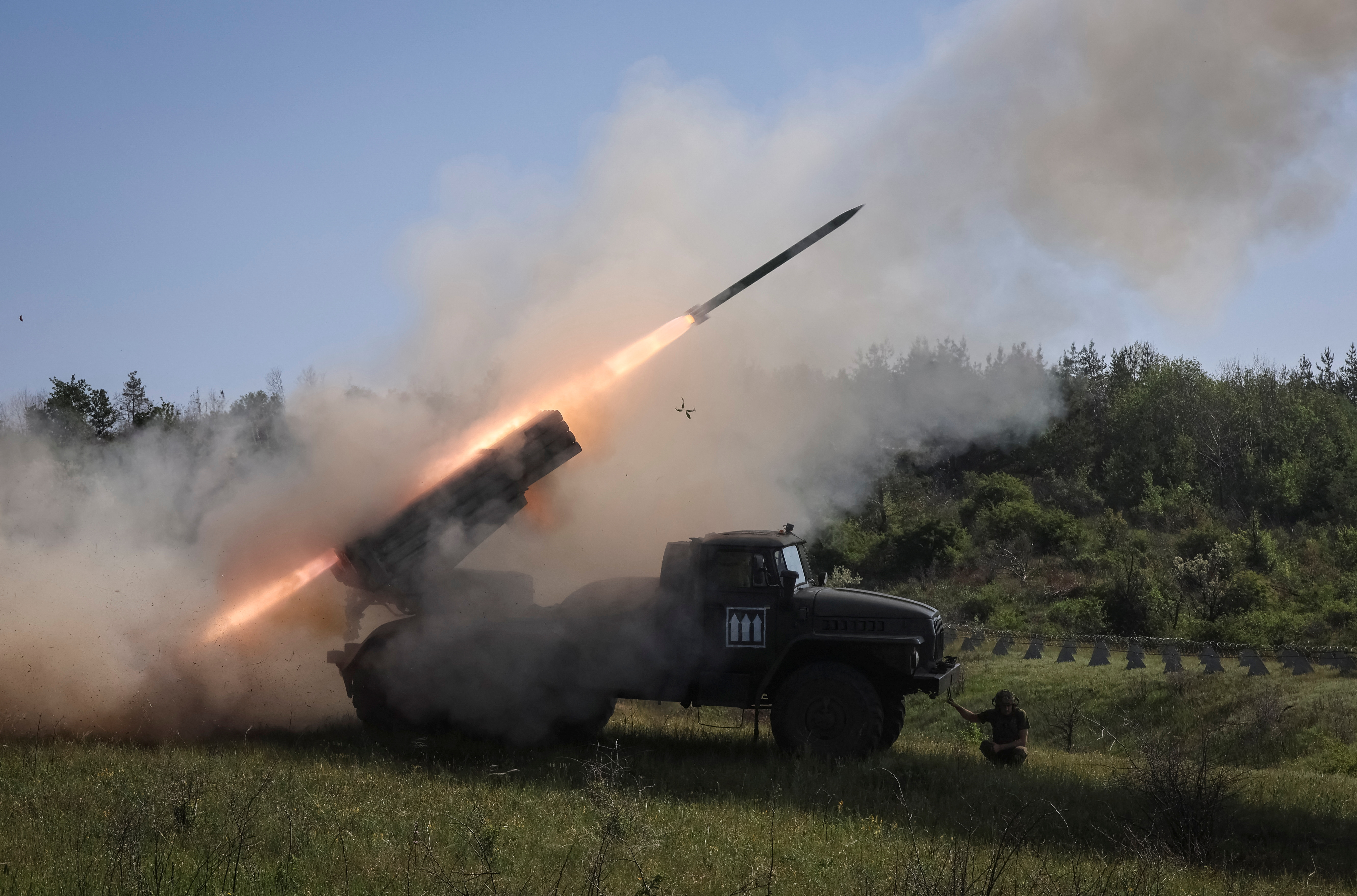 Ukrainian soldiers fire a BM-21 Grad rocket launcher toward Russian positions in Donetsk region, June 2025