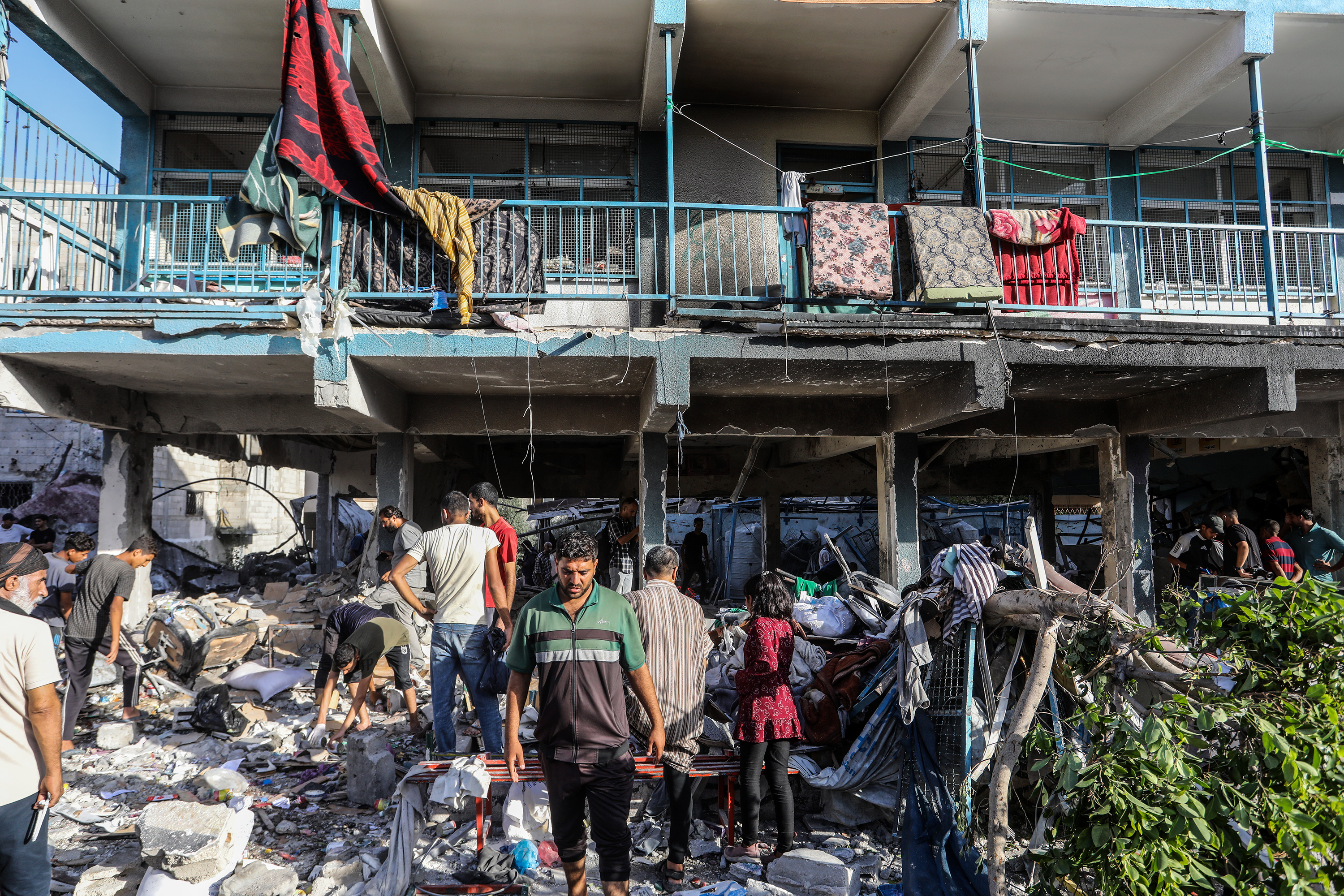 Rescuers search rubble of destroyed UNRWA school in Nuseirat Gaza after Israeli airstrike September 2024