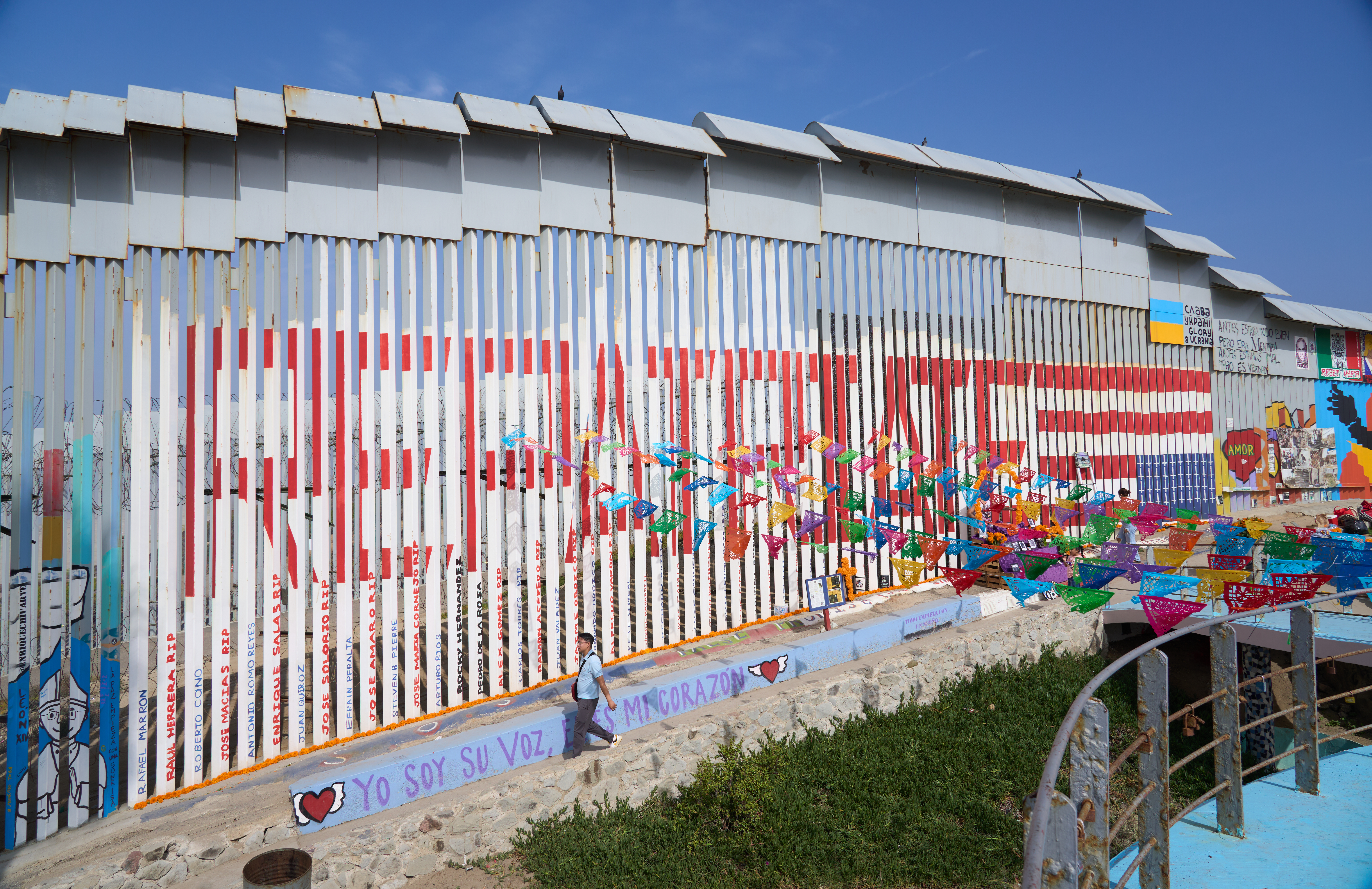 A mural on the border wall between San Diego and Tijuana shows an upside-down US flag and the word Repatriate
