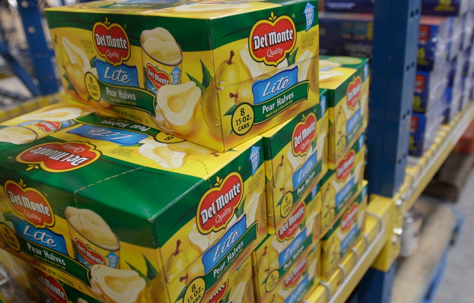Canned Del Monte products on display in a warehouse, an emblem of US mid-market consumer goods