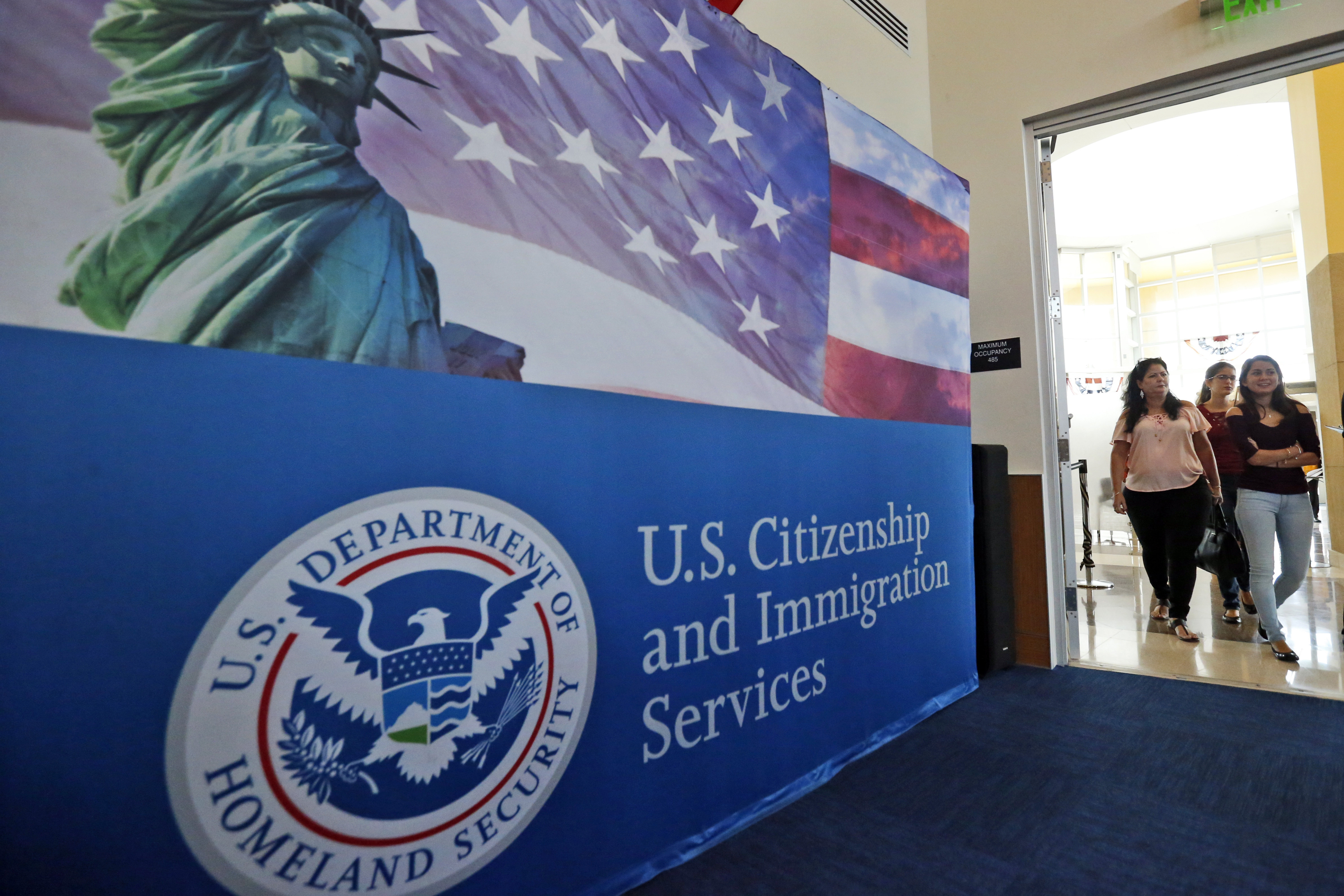 People arrive for a naturalization ceremony at a US Citizenship and Immigration Services office in Miami