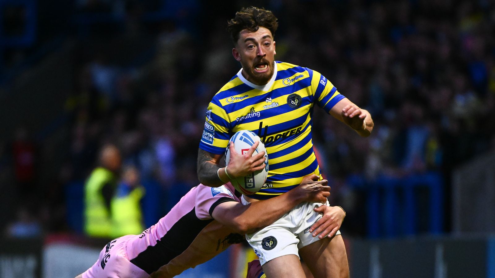 Matty Ashton of Warrington Wolves tackled during Super League Round 13 against Hull FC at Halliwell Jones Stadium