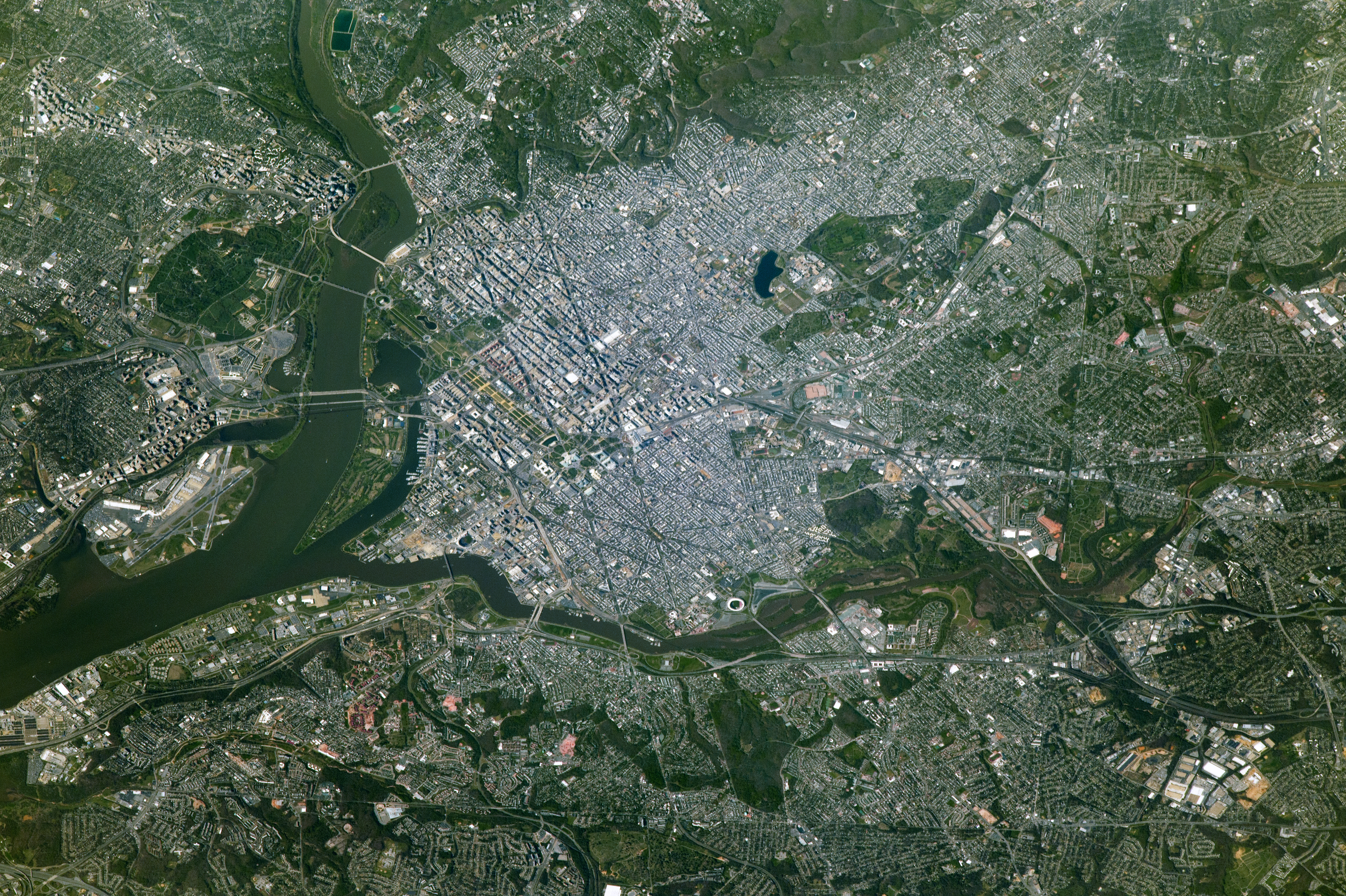 NASA astronaut photograph from the International Space Station of Washington DC showing the Potomac River the National Mall the Tidal Basin and the Kennedy Center on the riverbank with the Lincoln Memorial Washington Monument and US Capitol visible to the east