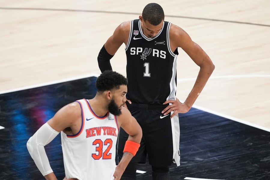 Victor Wembanyama of the San Antonio Spurs and Karl-Anthony Towns of the New York Knicks during Game 1 of the 2026 NBA Finals at Frost Bank Center