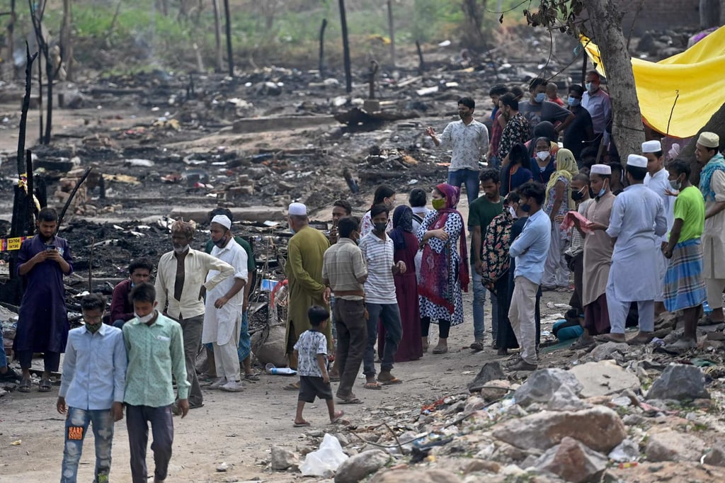 Undocumented Bangladeshi migrants wait at a border crossing point in West Bengal's North 24 Parganas district