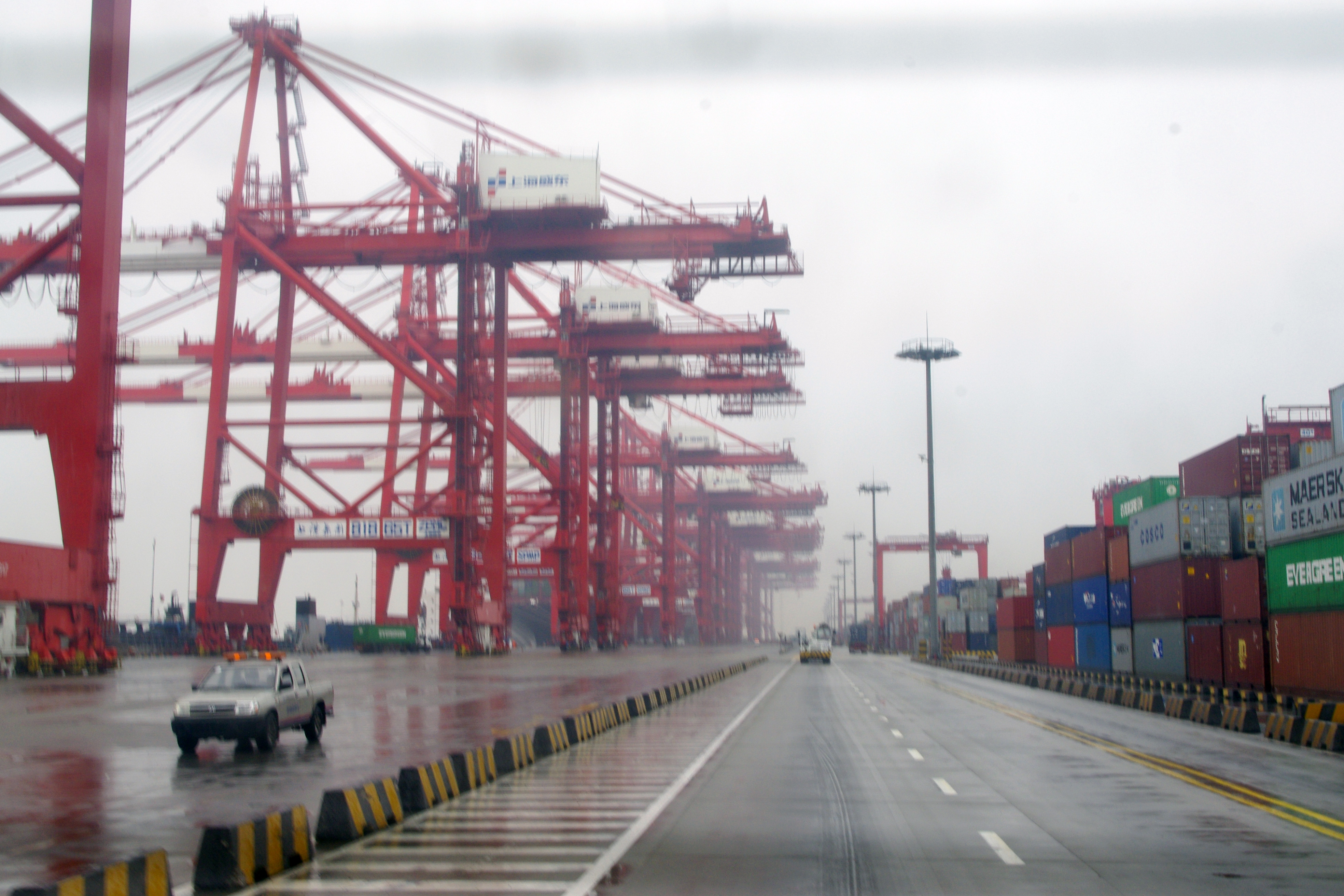 Stacked shipping containers and cranes at Yangshan deep-water port in Shanghai, China