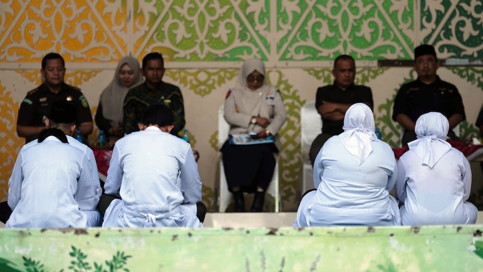 People await public caning in Banda Aceh under Indonesia Aceh Islamic Criminal Code enforcement