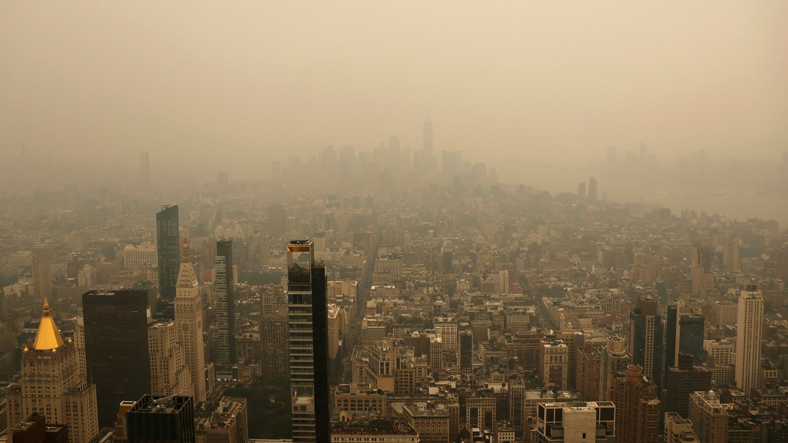 Wildfire smoke from Canadian wildfires creates orange haze over New York City skyline