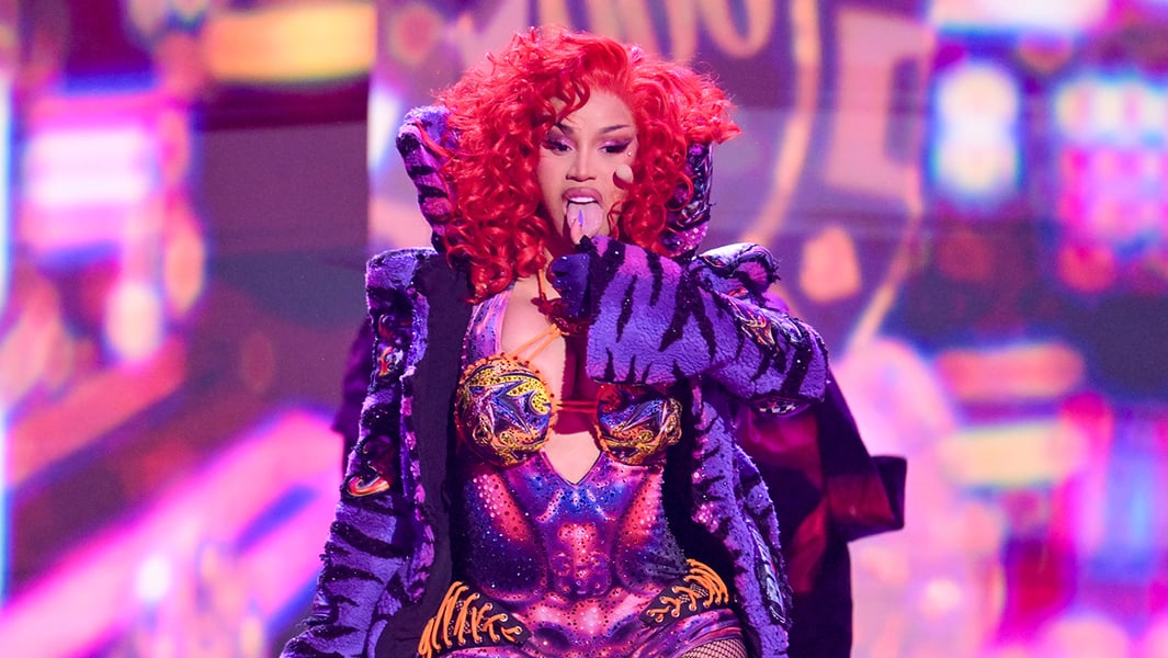 Cardi B performing at the 2026 BET Awards in a colorful bodysuit with fiery red hair