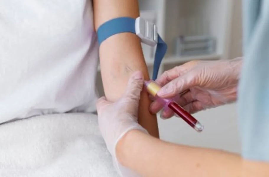 Healthcare professional reviewing a patient's cholesterol blood test results to assess cardiovascular risk and determine whether statin therapy is appropriate.