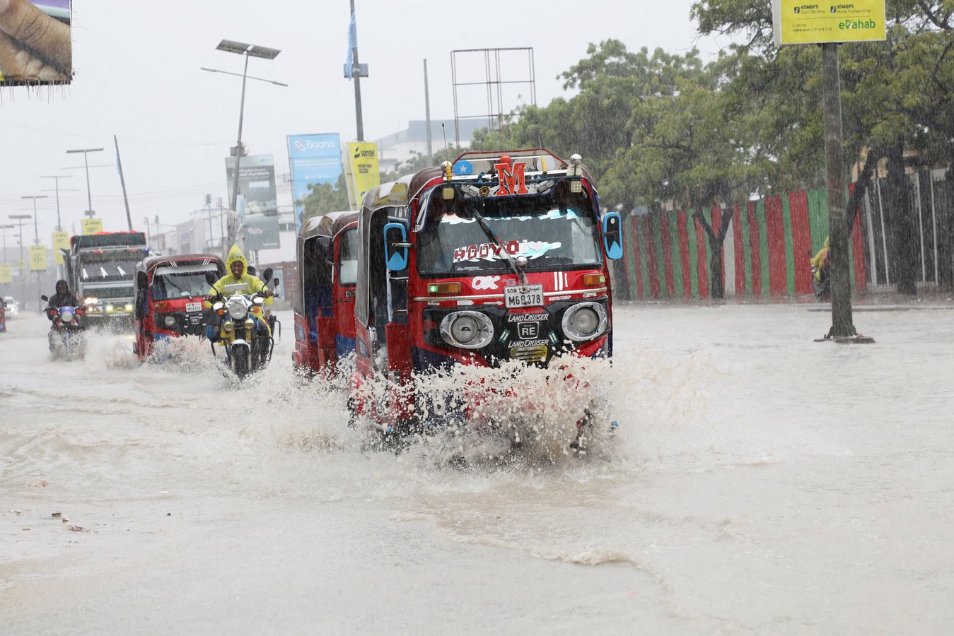 Tuktuks navigate floodwater on KM4 street in Mogadishu Somalia during El Nino flooding 2026