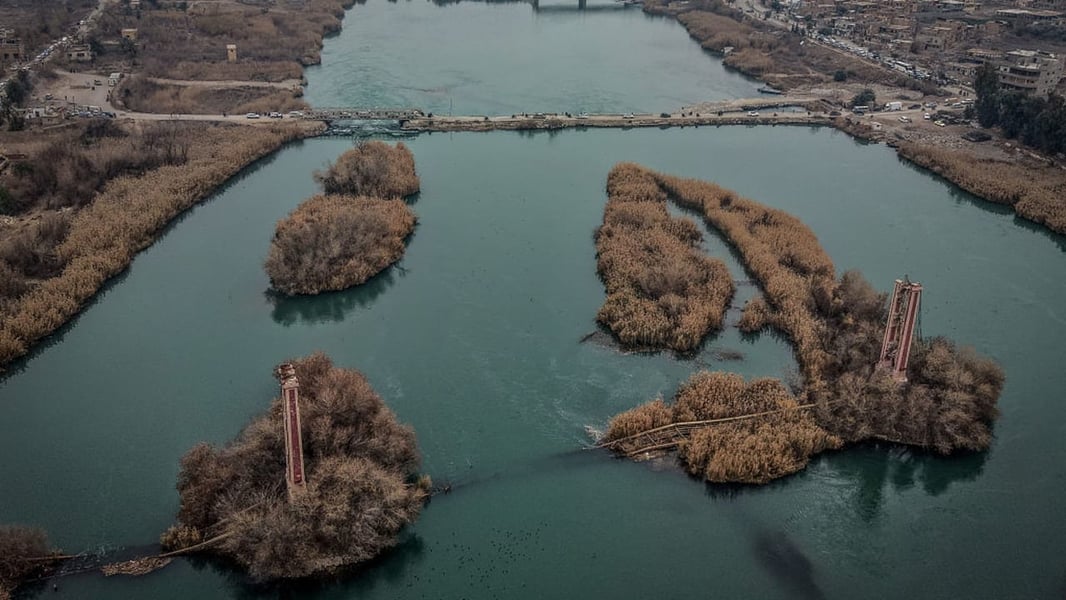 Syrian Civil Defense rescue teams search the Euphrates River near Deir Ezzor after ferry hits bridge killing two children