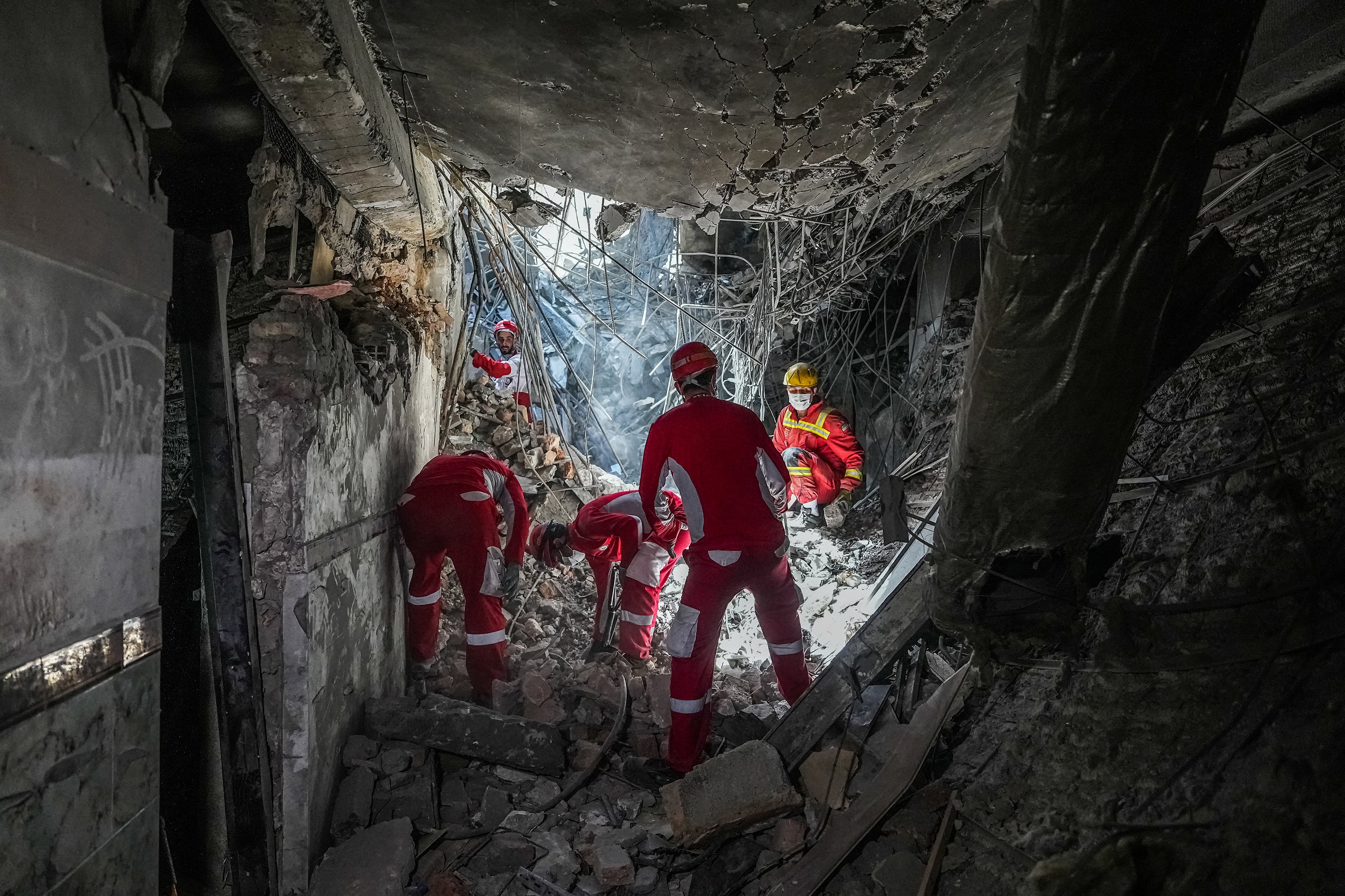 Rescue workers sift through rubble inside Evin Prison complex in Tehran after Israeli airstrike June 2025